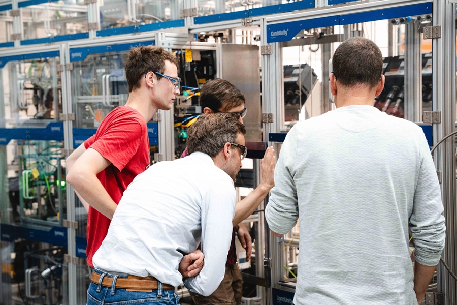 Engineering team conducting a walk-through inspection of a modular process system during technology scale-up