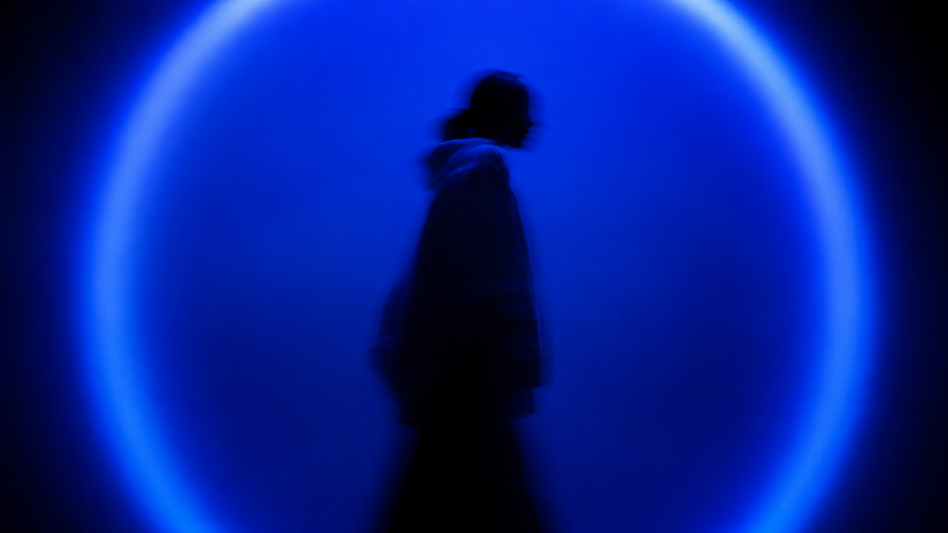 A woman inside a blue light circle