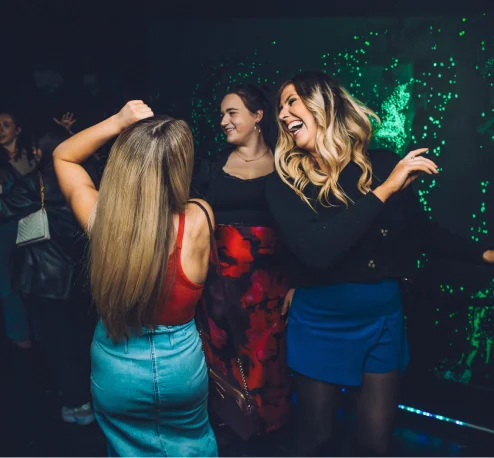 Women laughing together during a Wake The Tiger After Hours adults-only evening