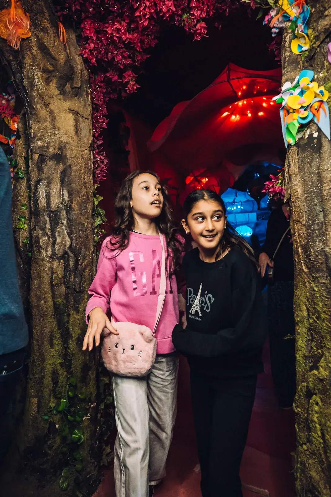 Two girls exploring a themed tunnel inside Wake The Tiger