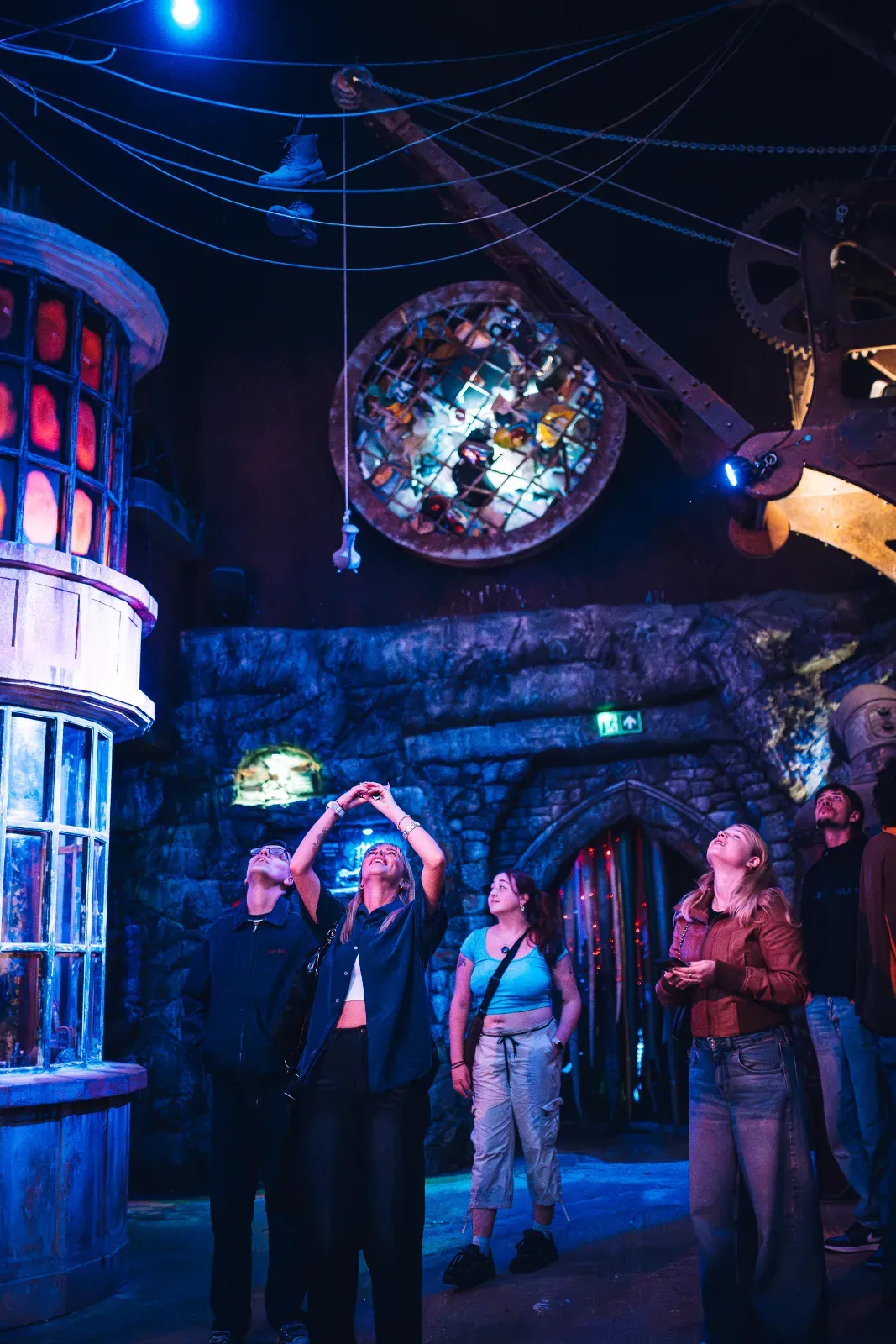 Visitors exploring a dark, themed room inside Wake The Tiger