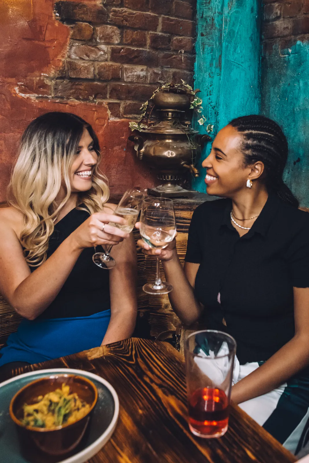 Women enjoying drinks at Junktion bar inside Wake The Tiger.
