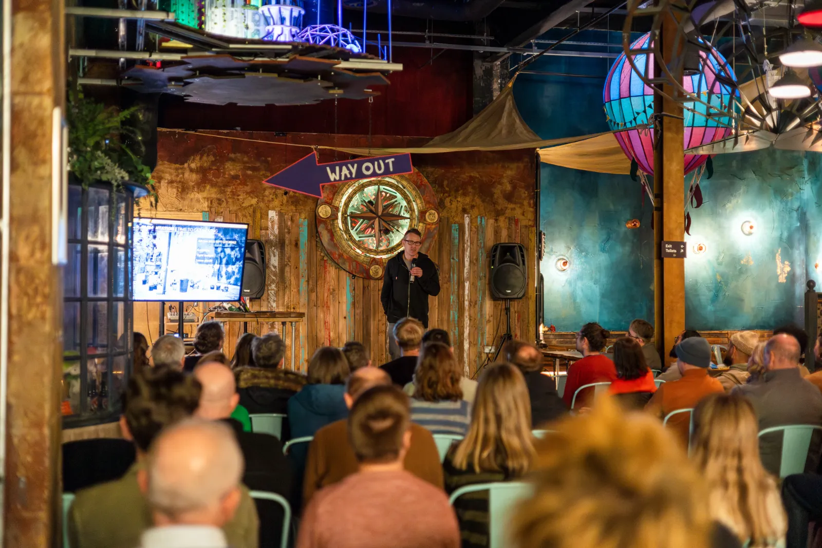 Speaker giving a presentation to a crowd at Wake The Tiger.