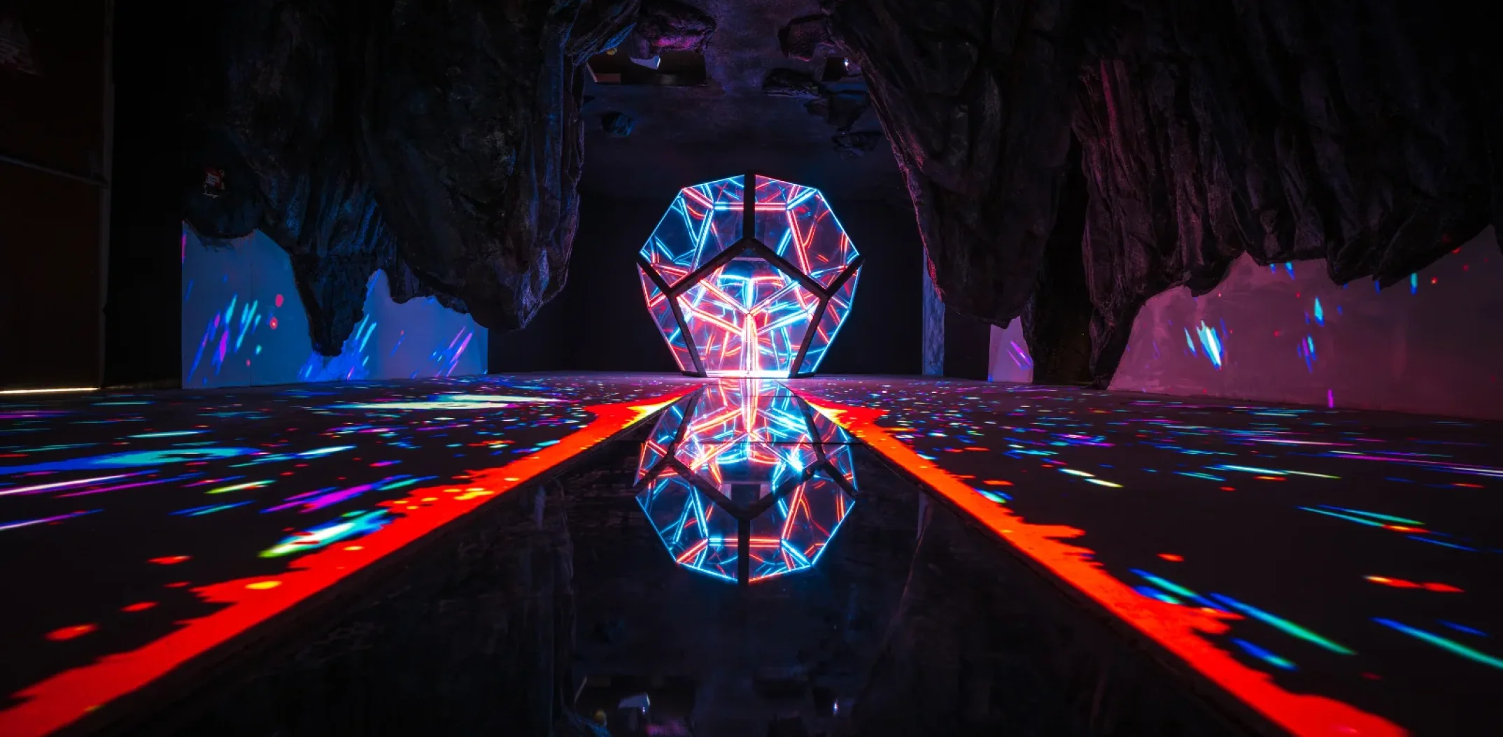 Neon geometric shapes lighting the cave installation at Wake The Tiger