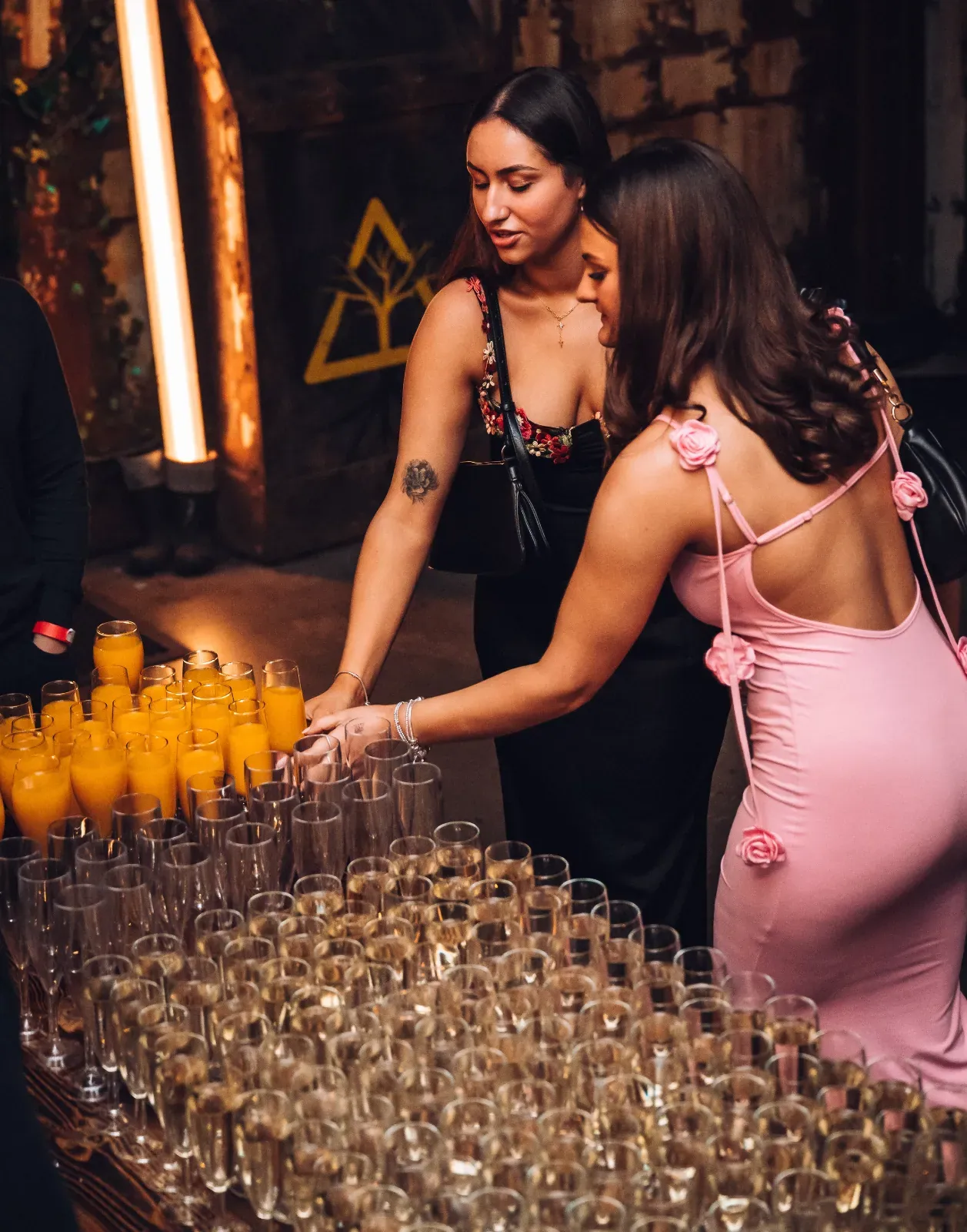 Guests pouring champagne at an event at Wake The Tiger
