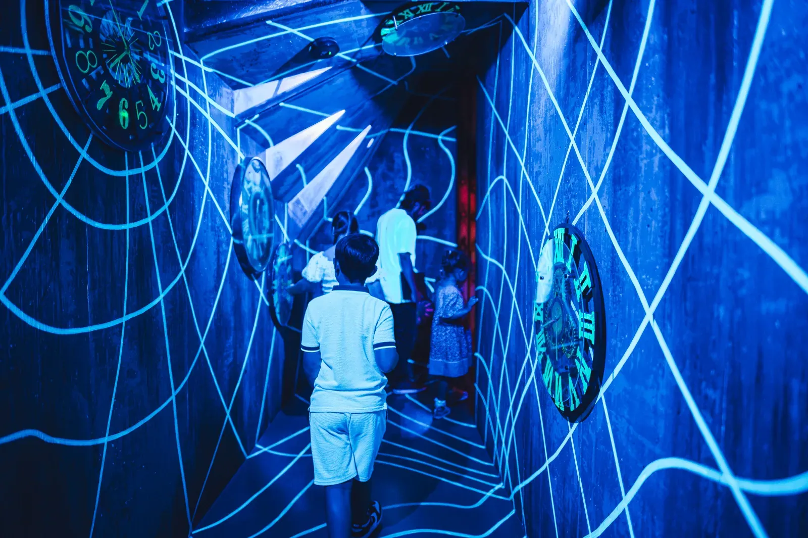 Family exploring a glowing time tunnel at Wake The Tiger
