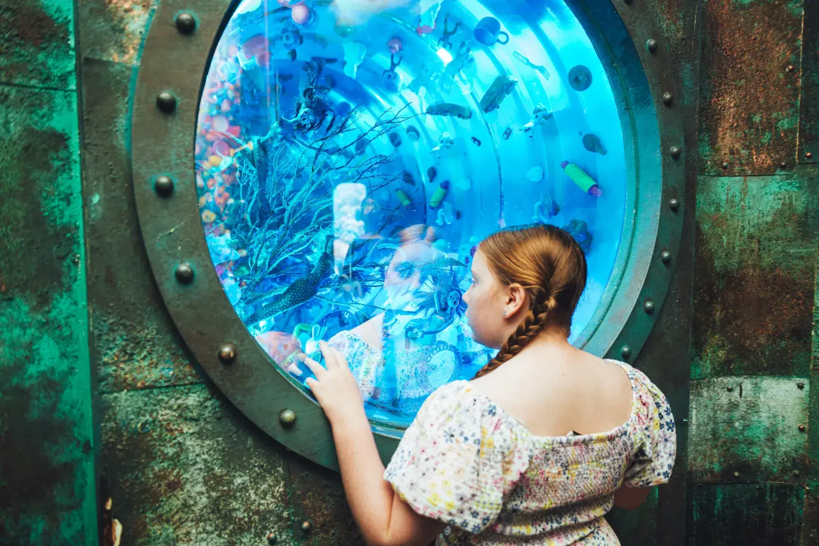 Young girl looking at the underwater-themed display at Wake The Tiger