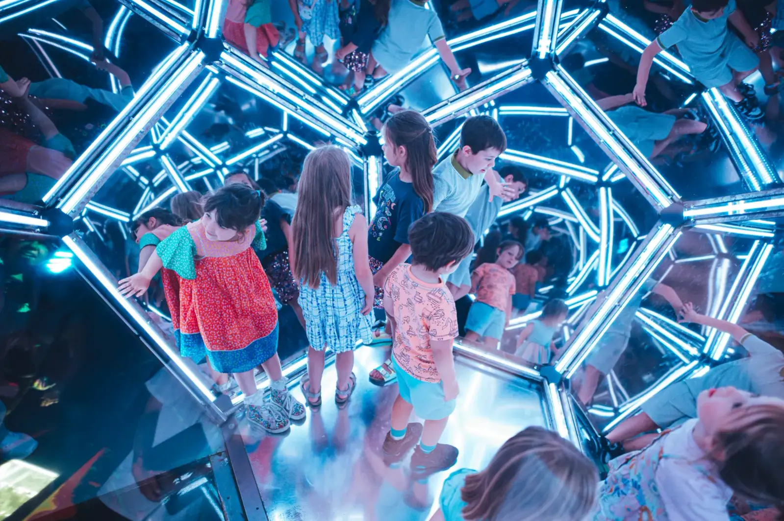 Children looking amazed inside the mirrored room at Wake The Tiger