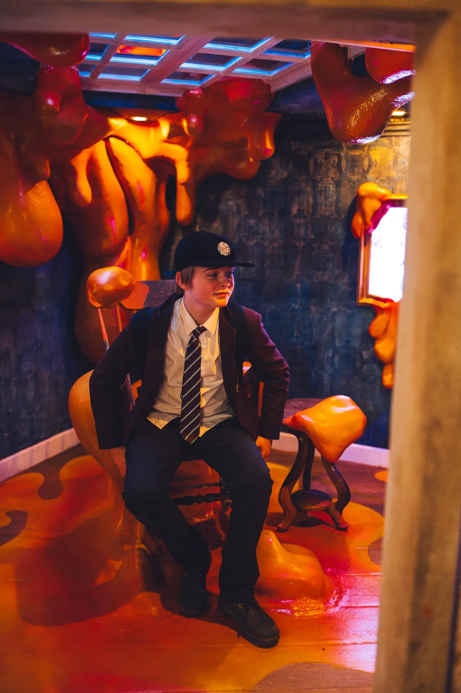 School boy sitting inside the orange ooze room at Wake The Tiger