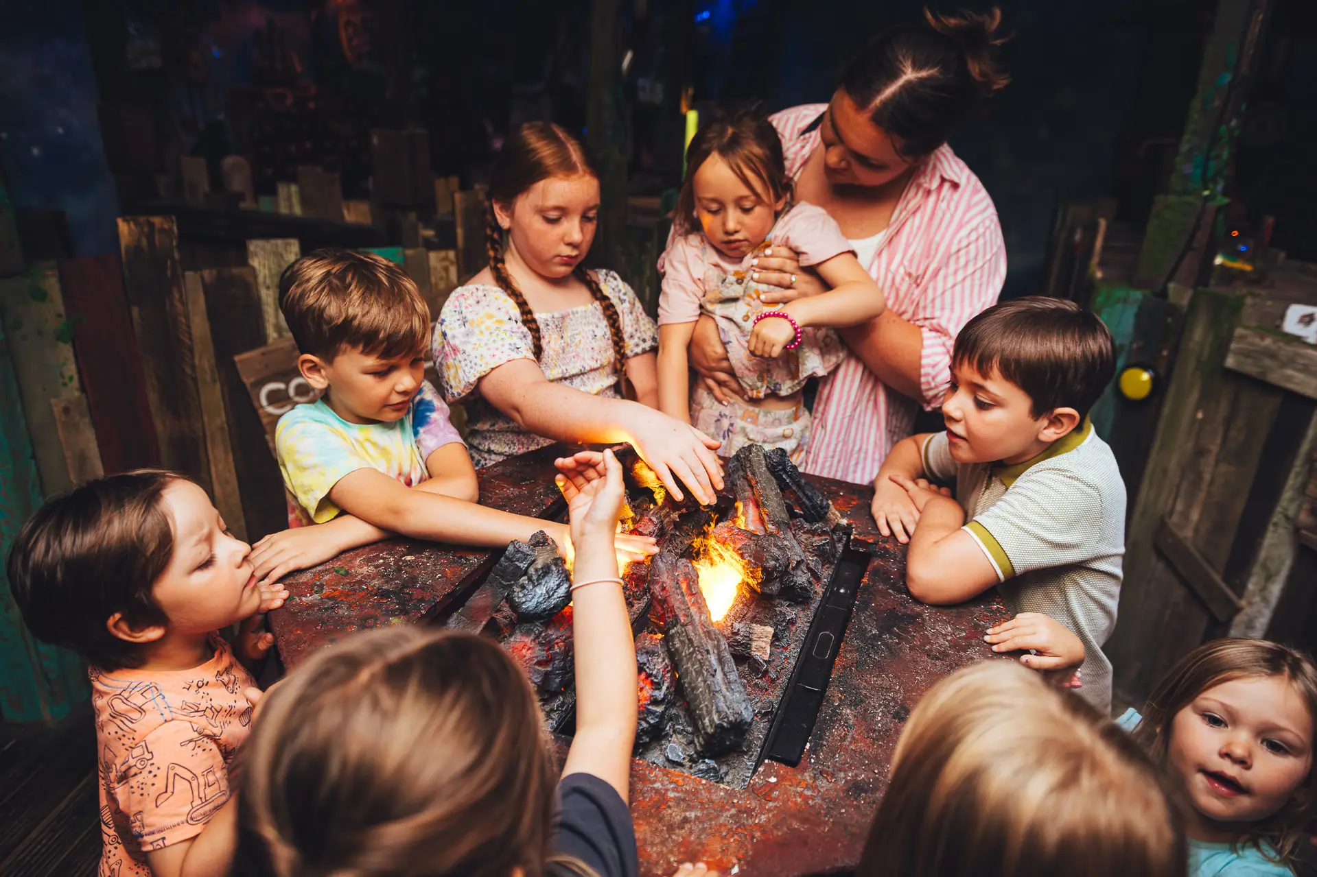 Children gathered around a fire installation at Wake The Tiger