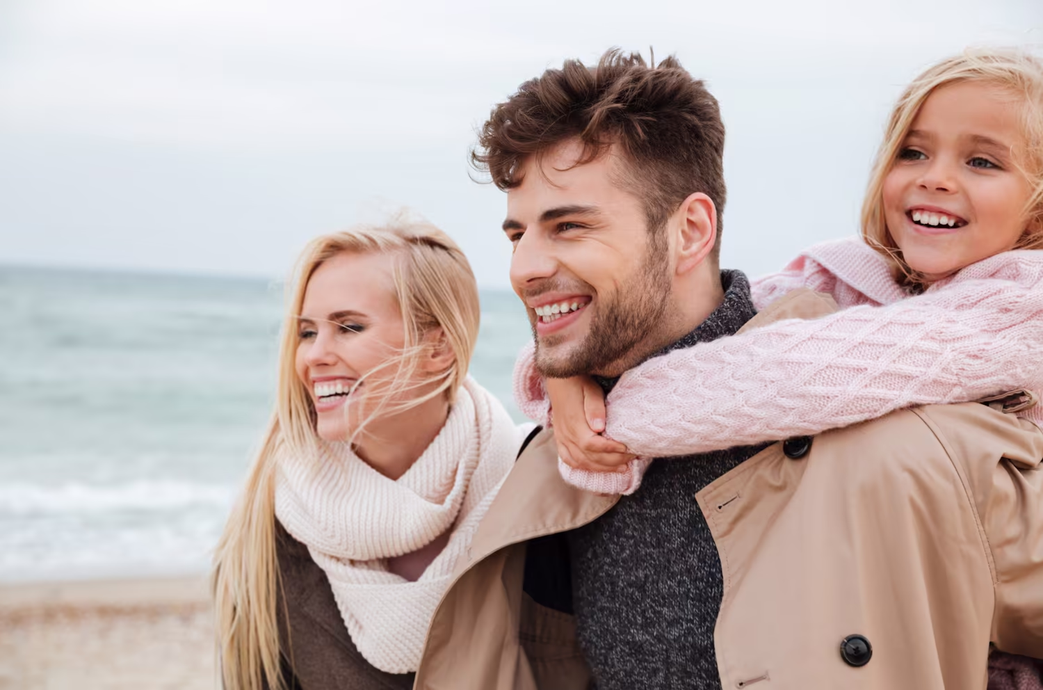 Smiling family outdoors by the water