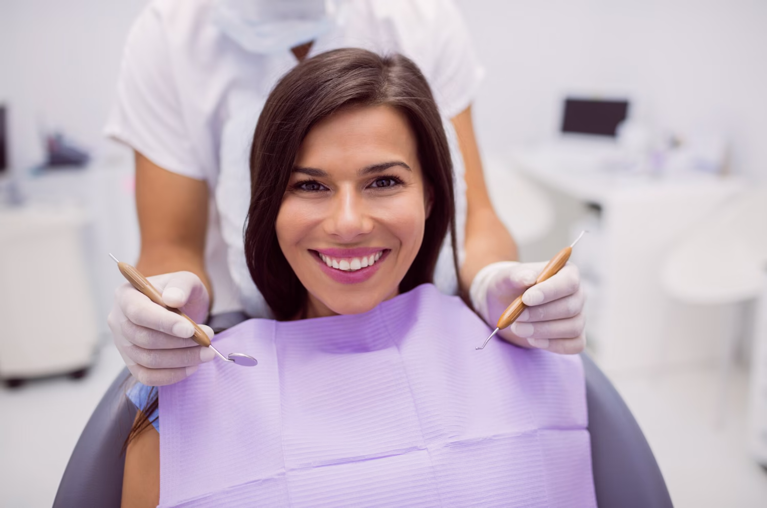 Smiling patient in the dental chair before treatment