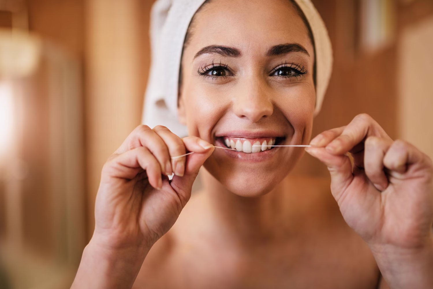 Woman flossing her teeth