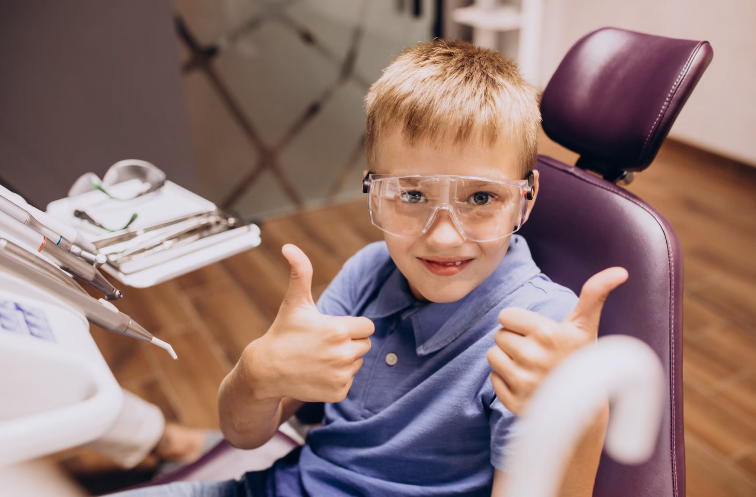 Child in safety glasses sitting in the dental chair