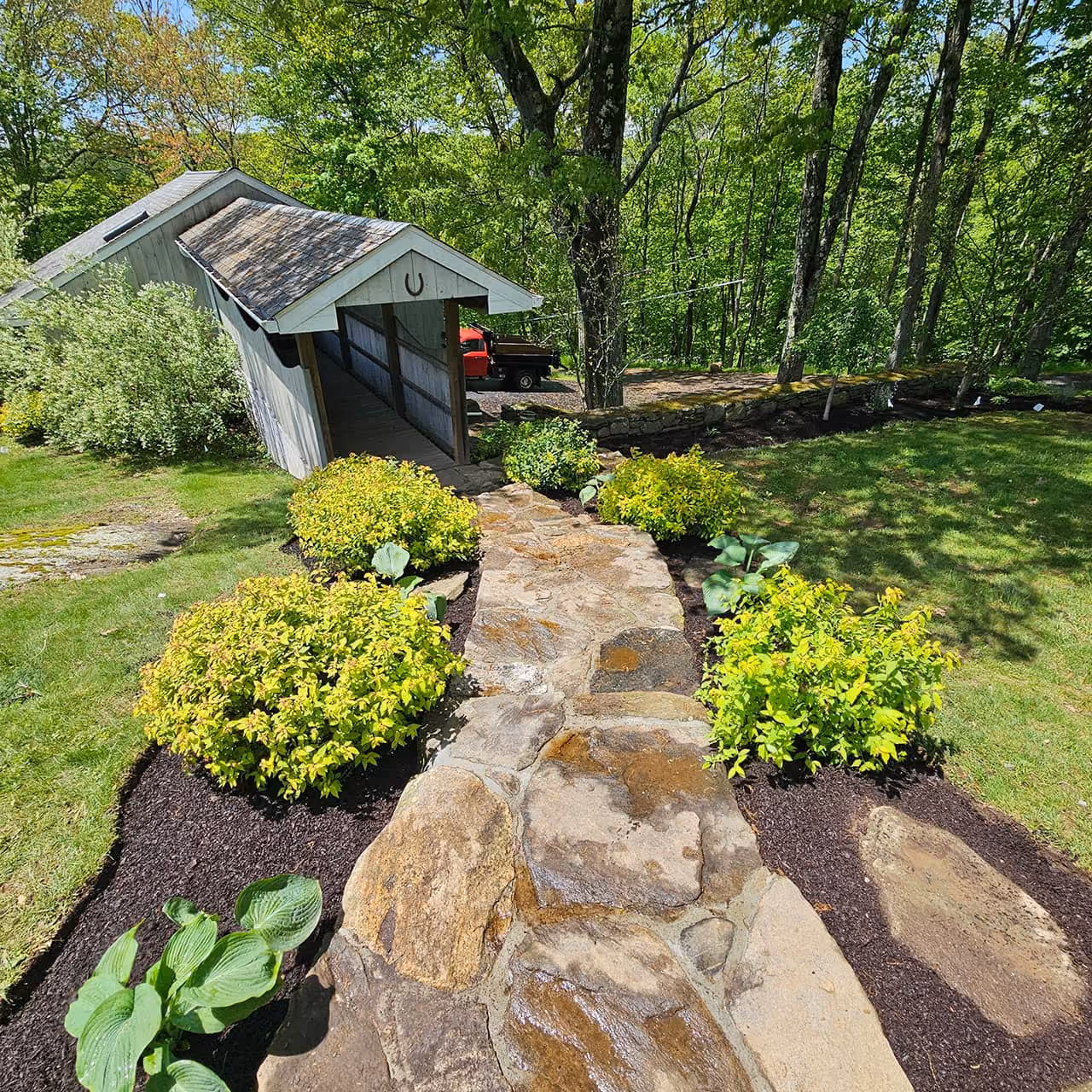 Garden planting and mulch refresh by Classic Outdoors near men