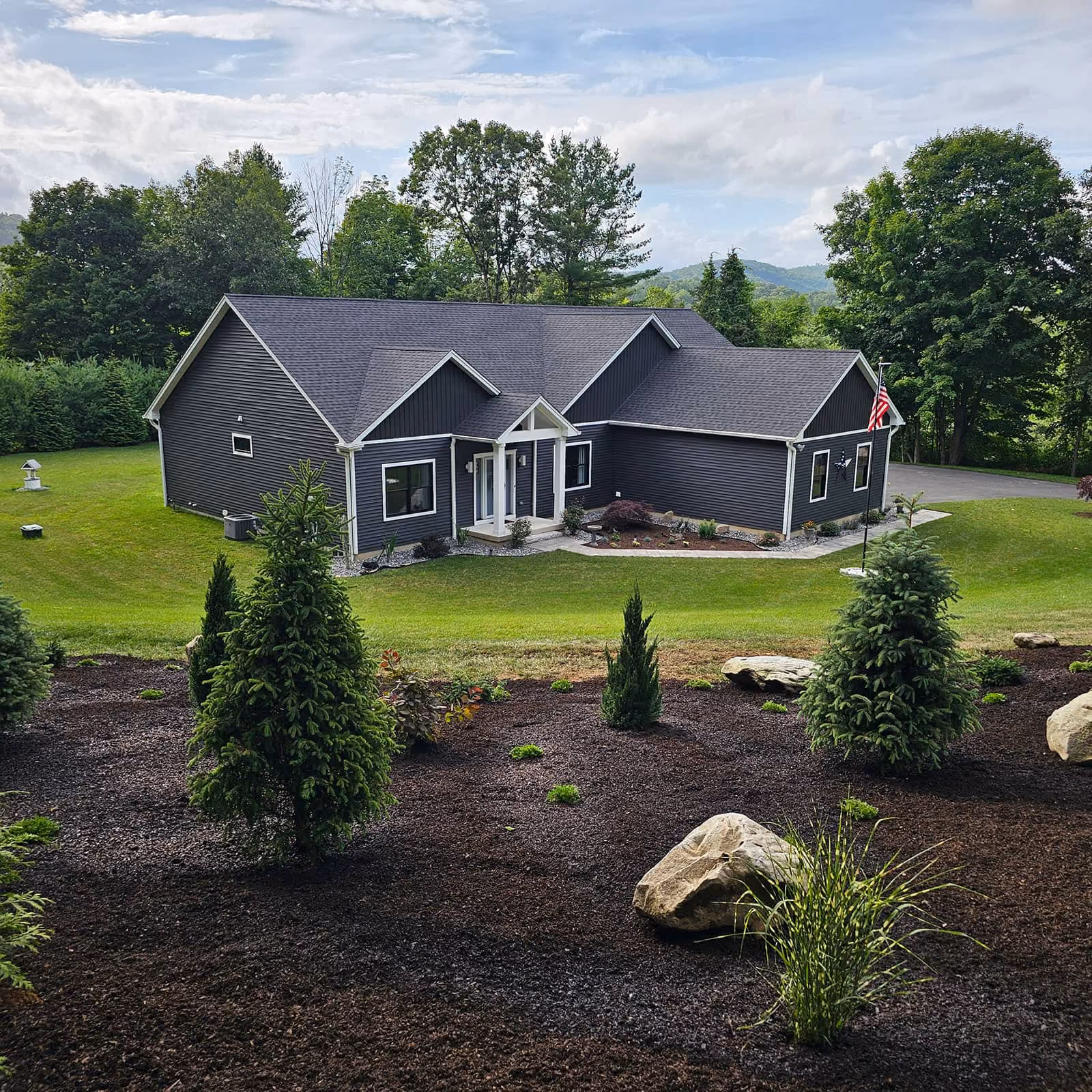 Classic Outdoors lawn-care crew mowing lush lawn near me in Warren CT