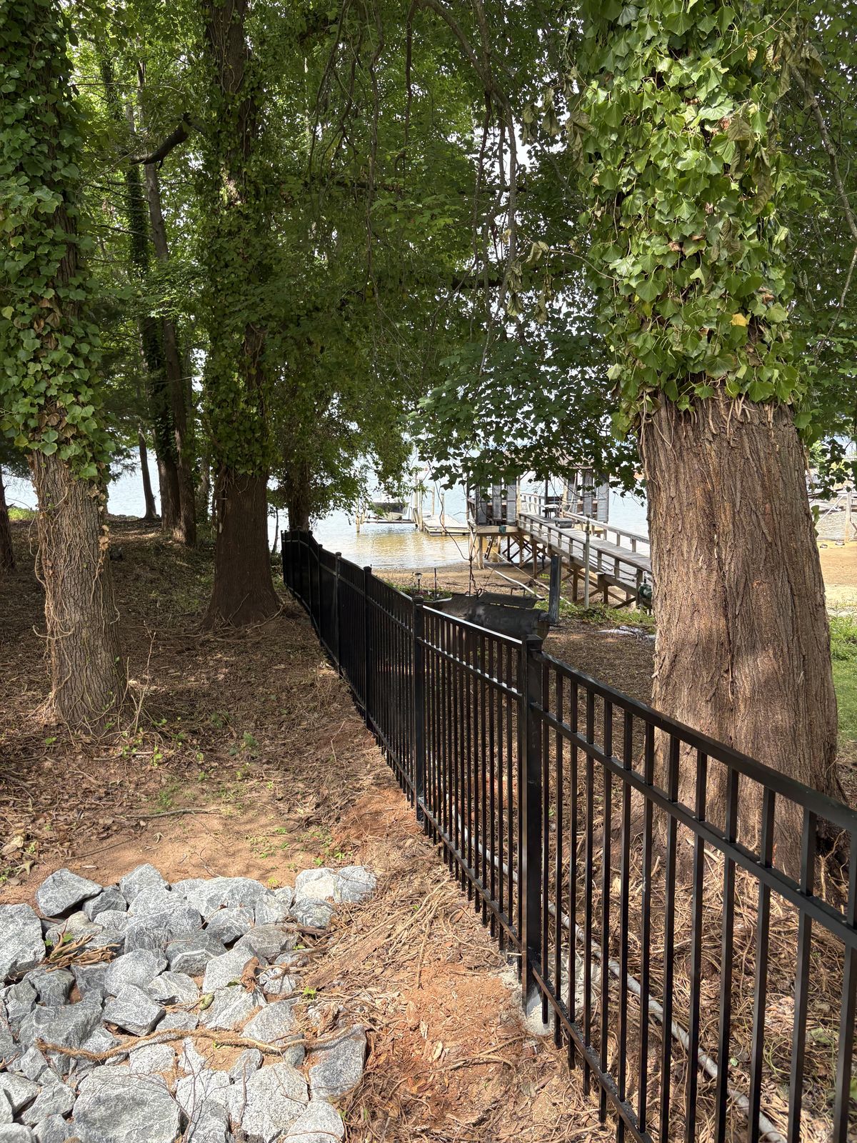 Aluminum fence installation near lakefront dock and shoreline in Lake Norman, NC