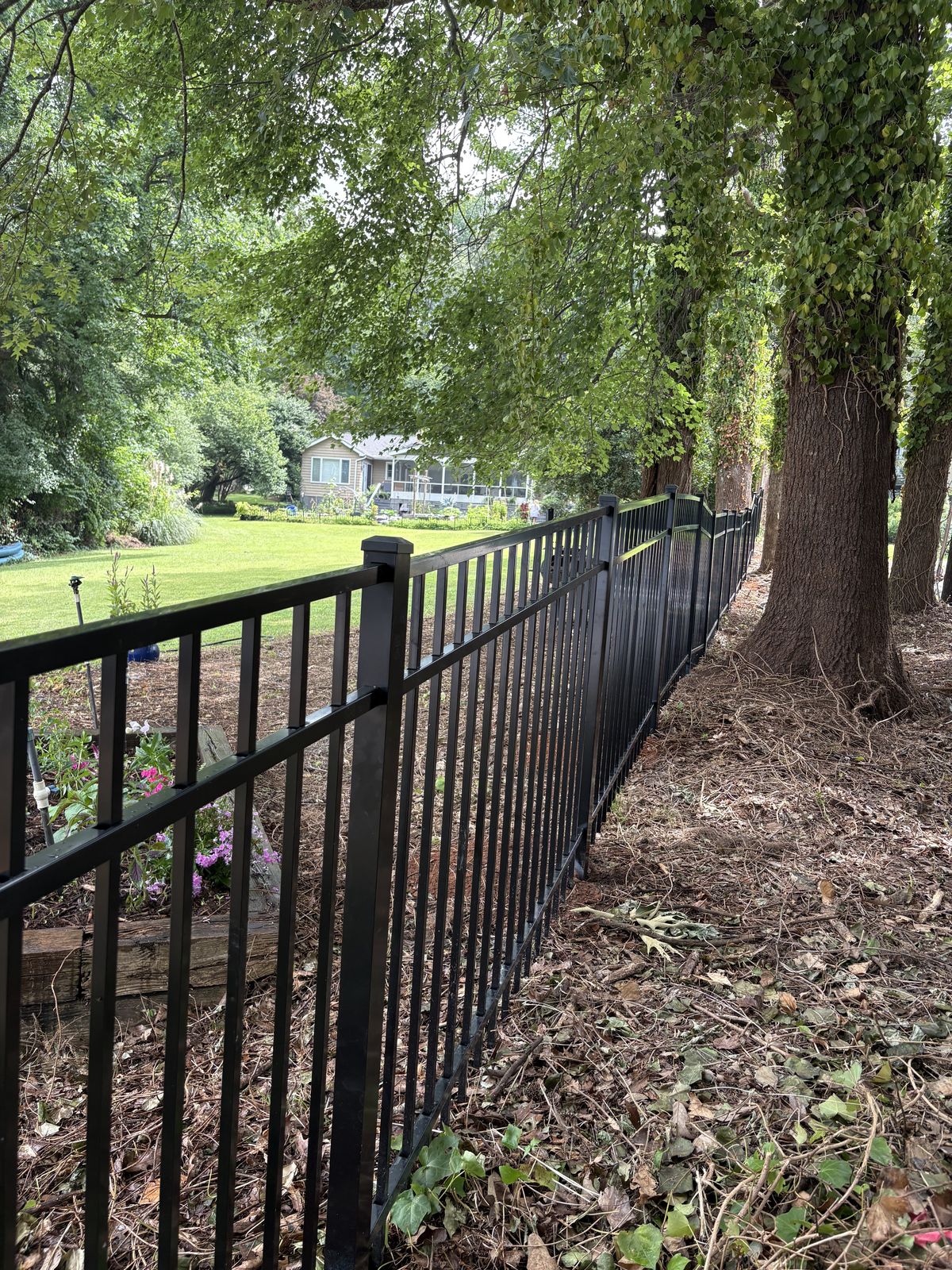 Black aluminum pool fence installation with self-closing gate near Lake Norman, NC