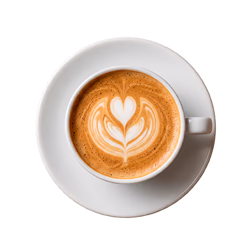 Top view of a white cup with latte art shaped like a heart and leaves on a saucer.