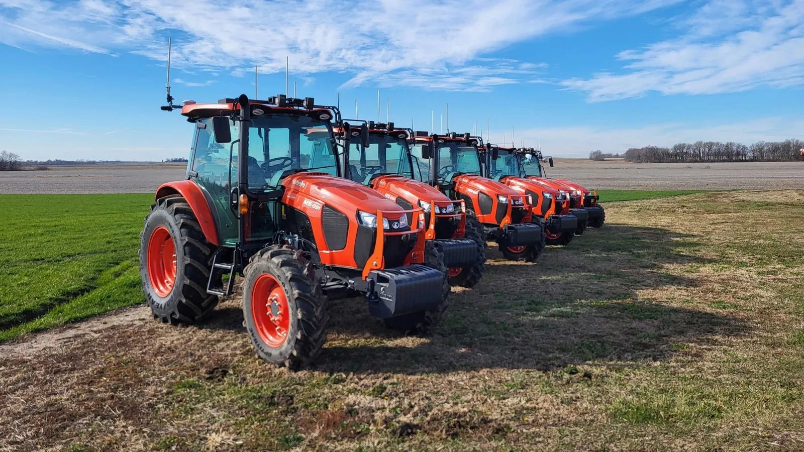 A fleet of autonomous tractors in a field.
