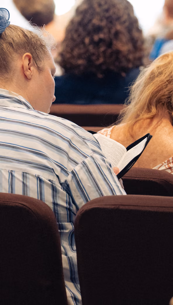 Person reading Bible while at church