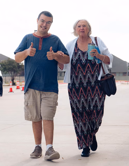 man woman walking smiling