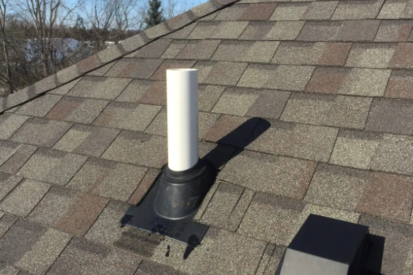 Radon vent pipe above roof line.