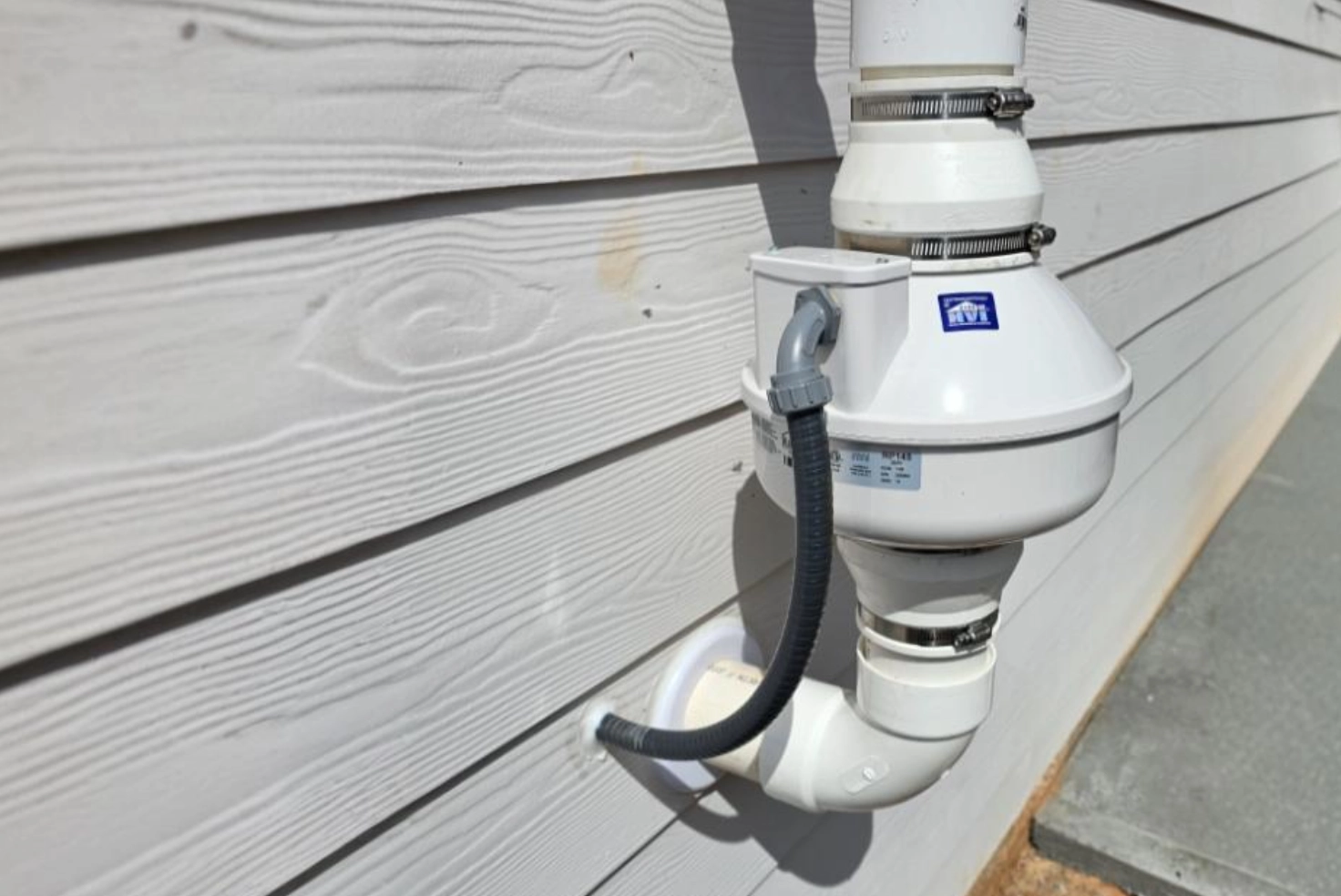 Radon mitigation system installed on exterior of a home