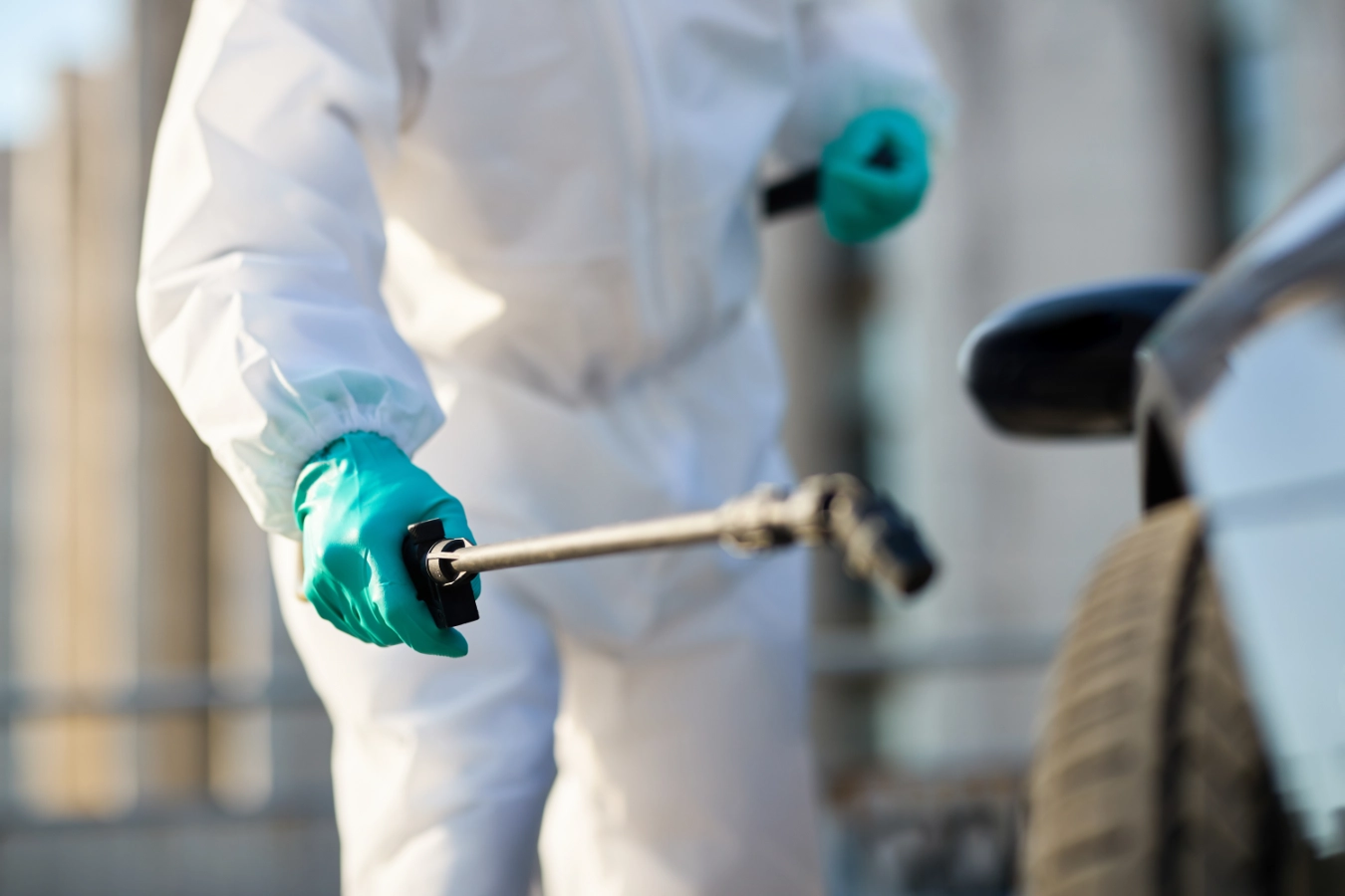 Mold Remediator wearing PPE and treating a surface for mold