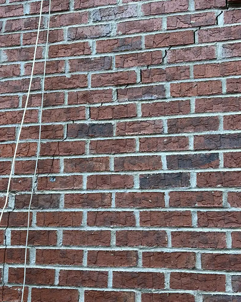 External brick cracking caused by moisture weakening the crawl space