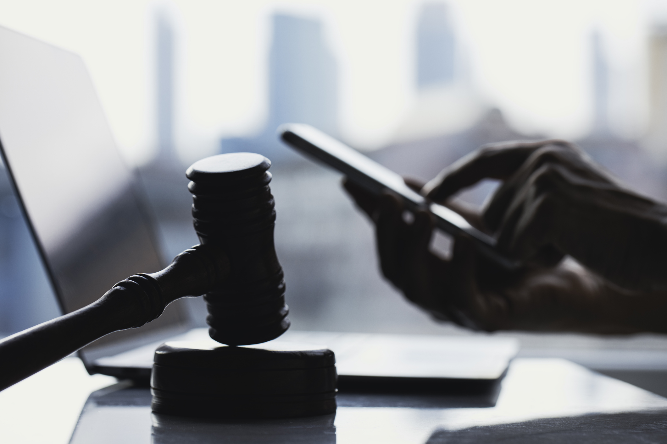 User with phone and court gavel