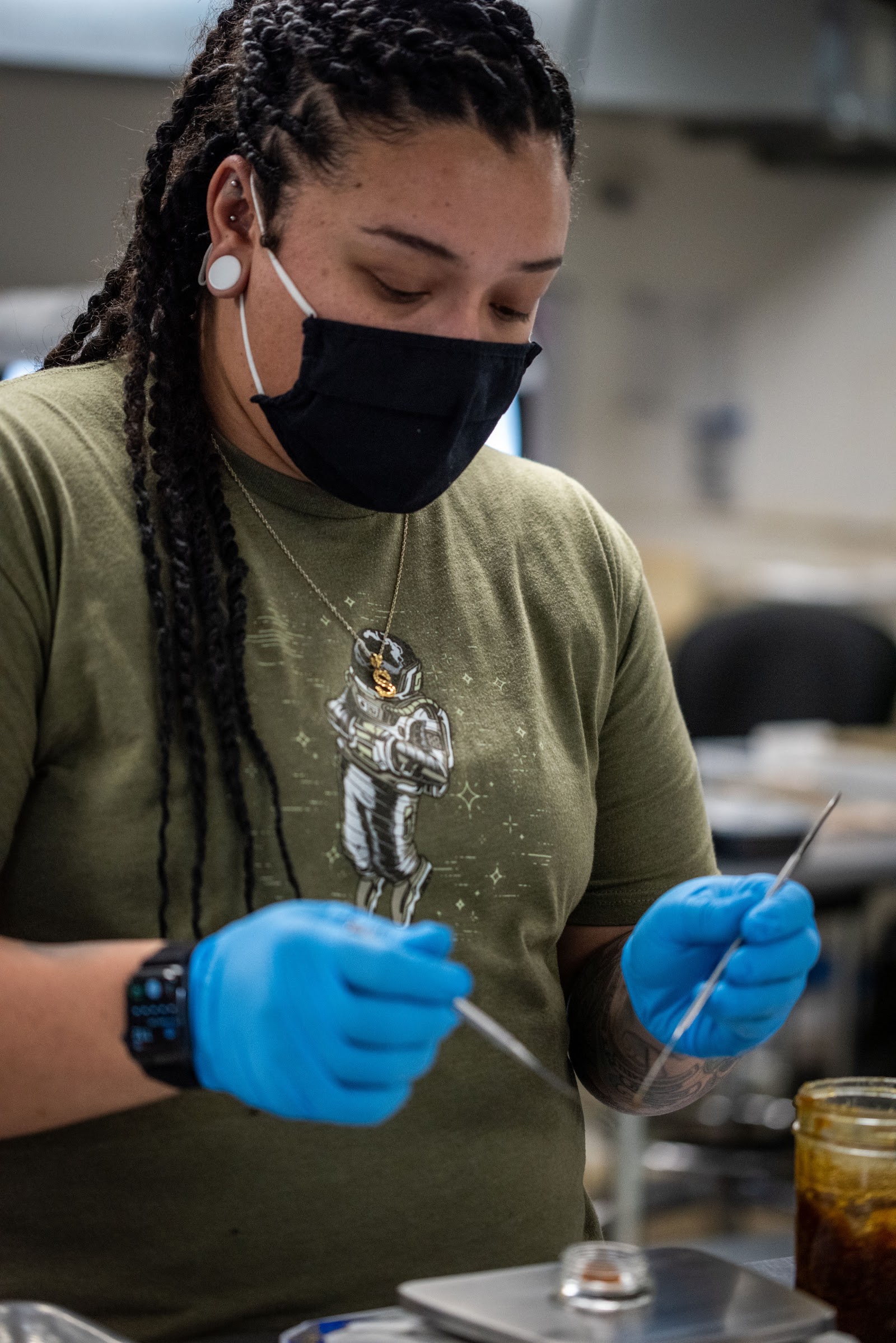 GOOD team member processing product with gloves and mask