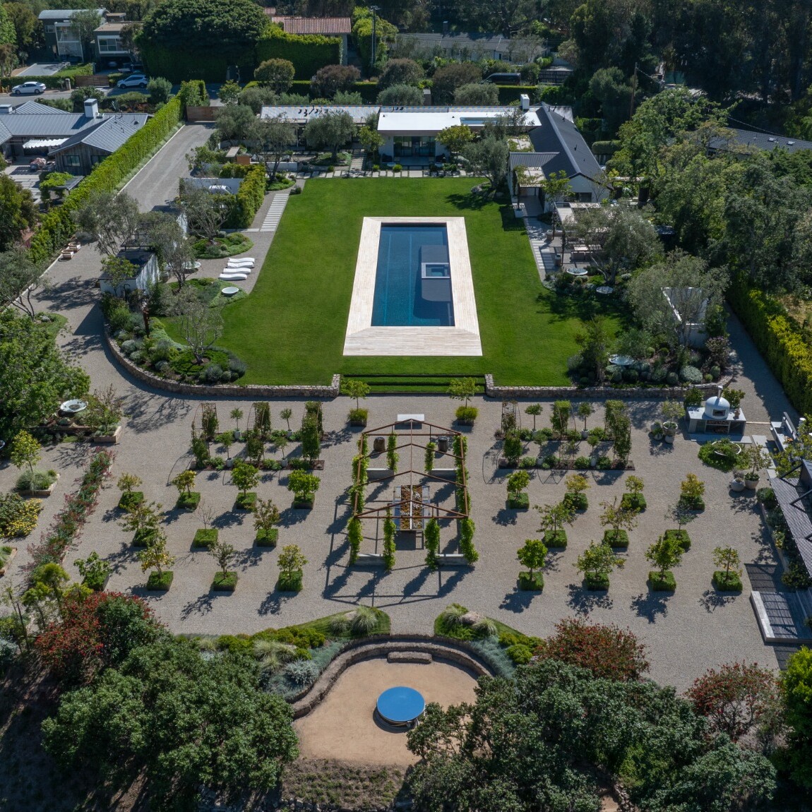 Aerial view of a landscaped backyard with pool and formal gardens, an outdoor living space built by ESK Construction Inc. in Los Angeles County