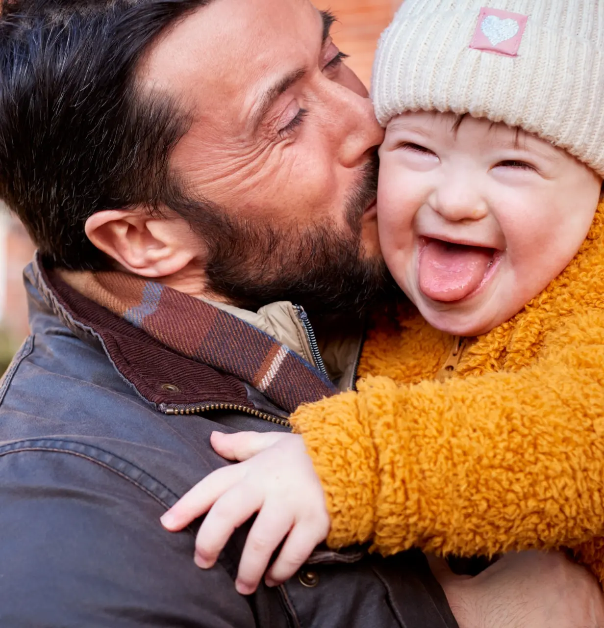 A father kisses his little boy