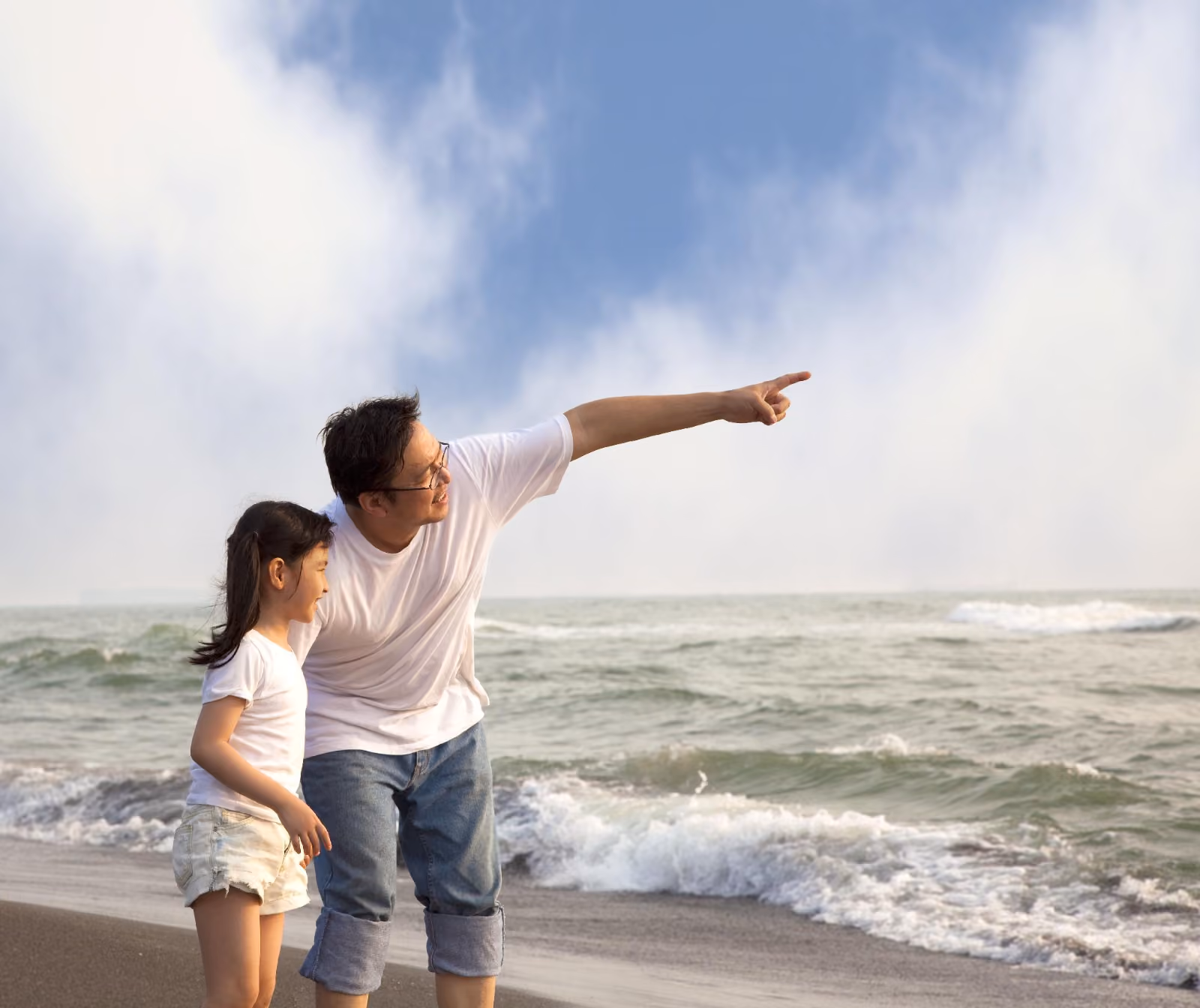 A father plays with his son in a cardboard box while the family cheers