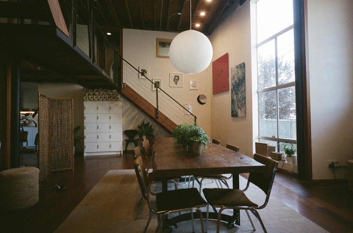 the communal table and loft staircase inside moss in venice beach