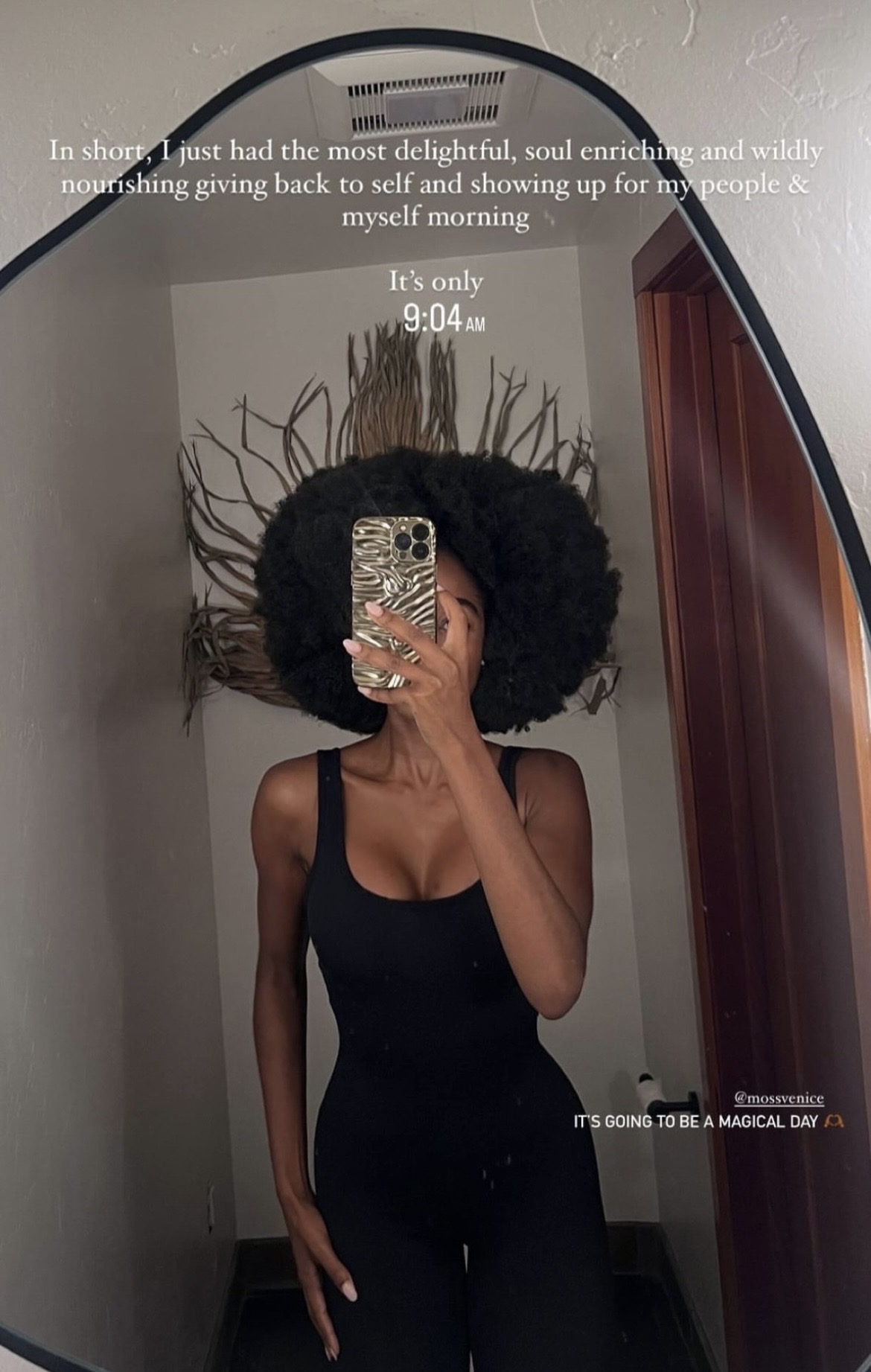 a member takes a mirror photo at moss after an early morning wellness session