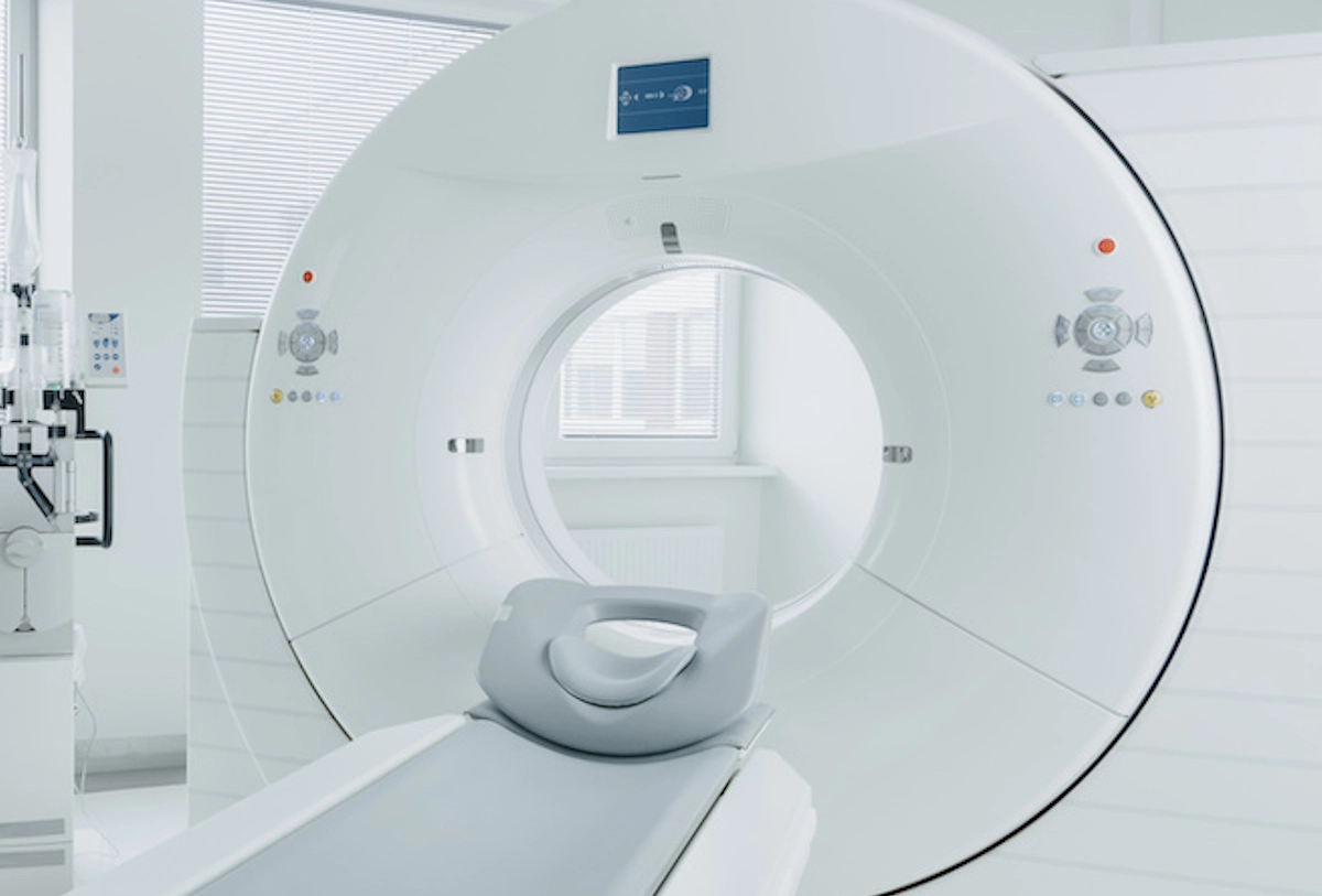 Empty CT scanner with open gantry and scanning table ready for patient imaging procedure