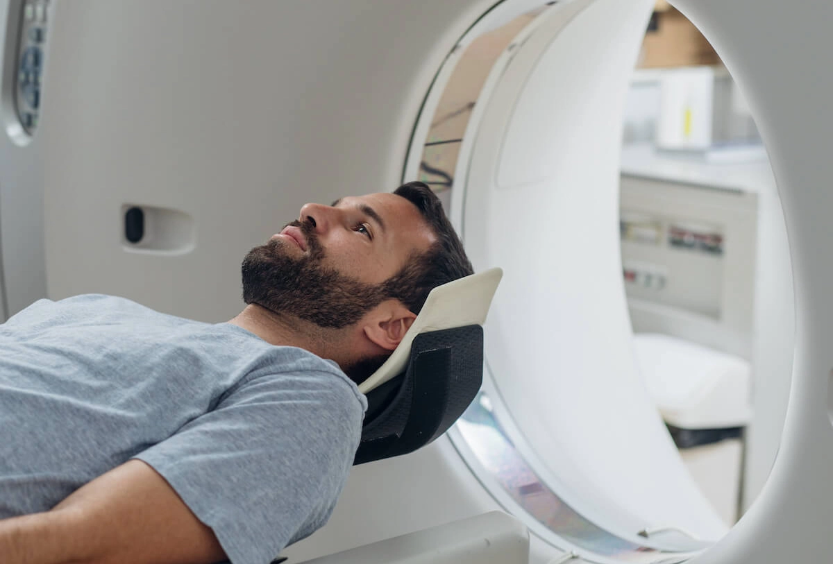 Patient positioned in CT or MRI scanner for diagnostic head imaging procedure