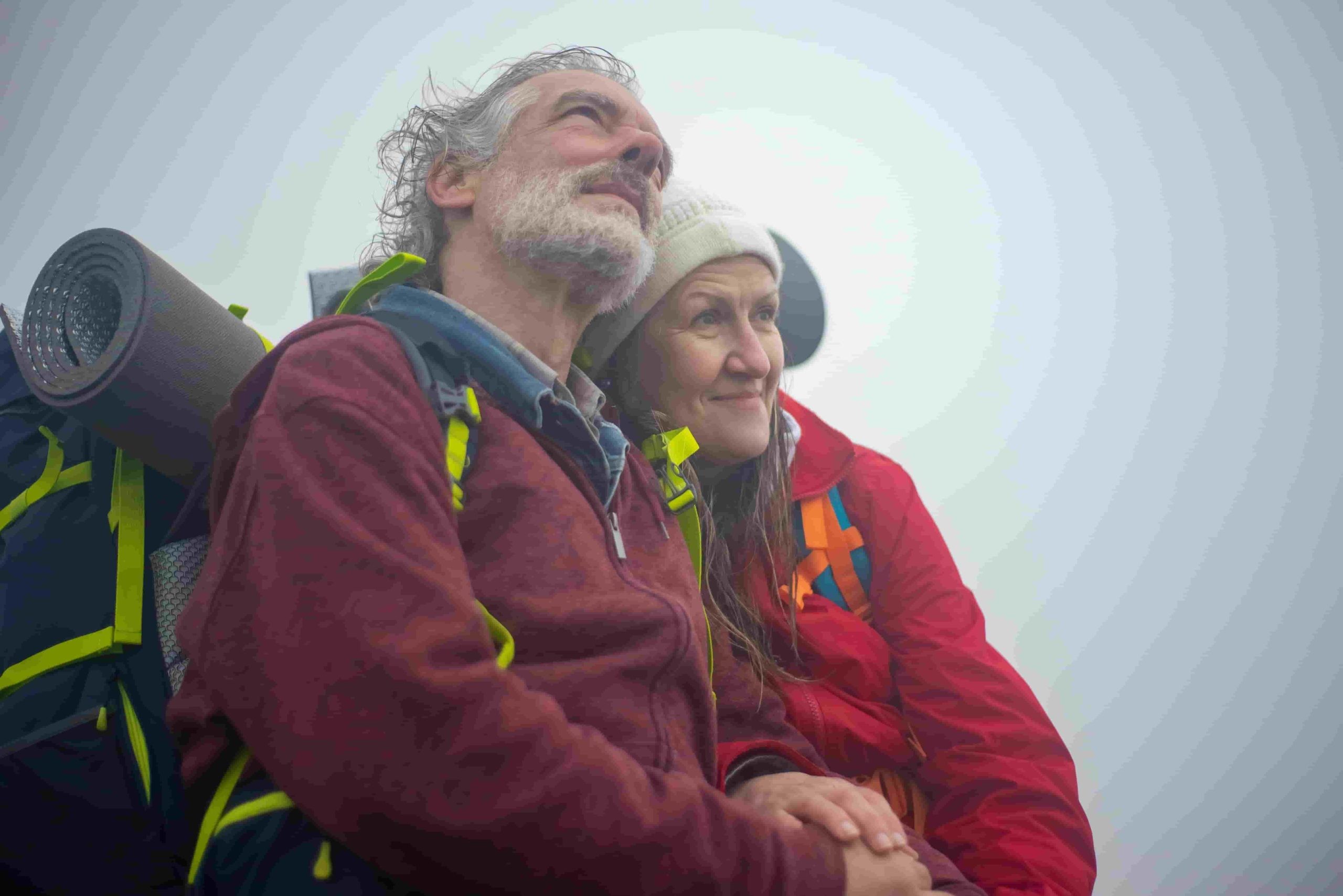 photo of a middle age couple about to embark on a hiking trip