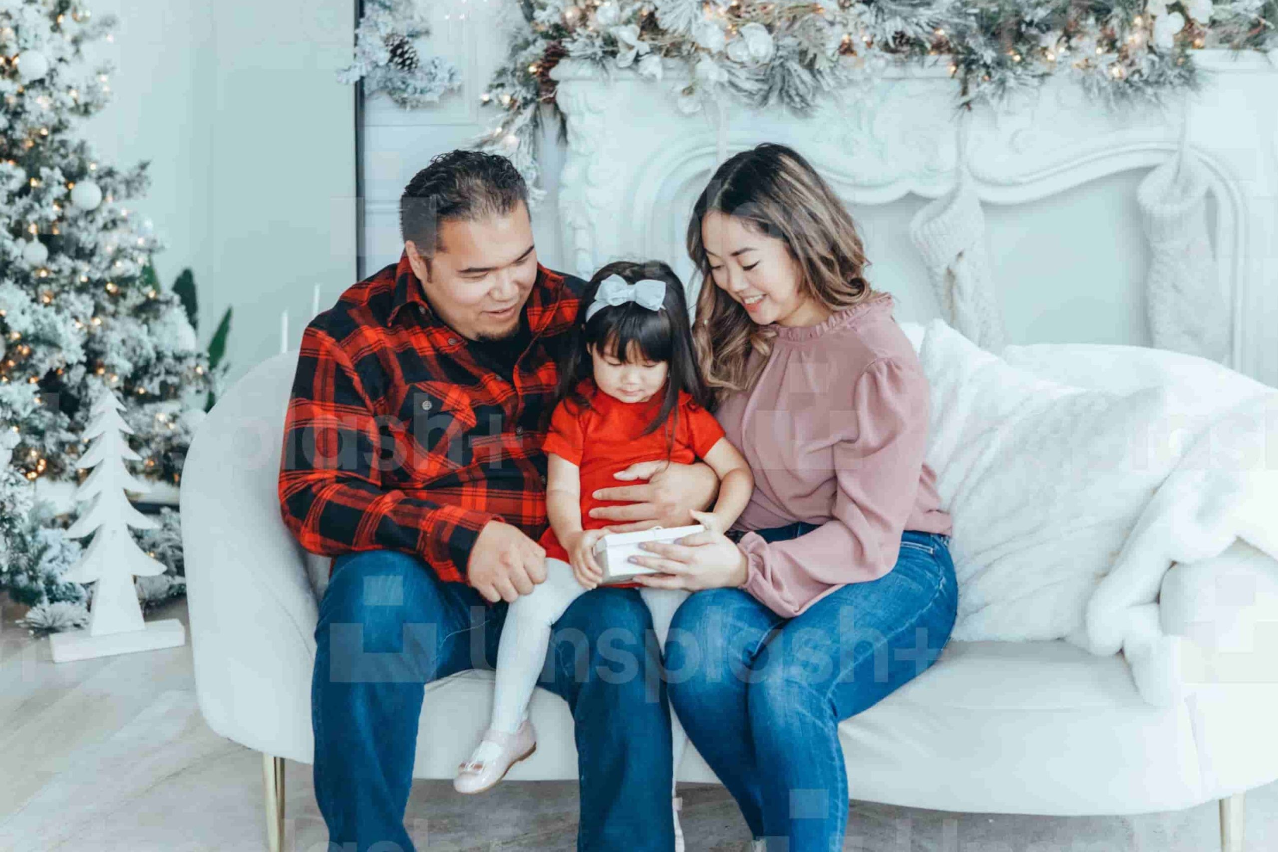 photo of a family of father and mother giving a gift to their child
