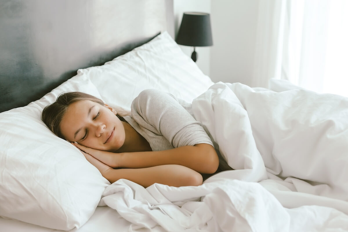 Aging backwards: woman sleeping in bed