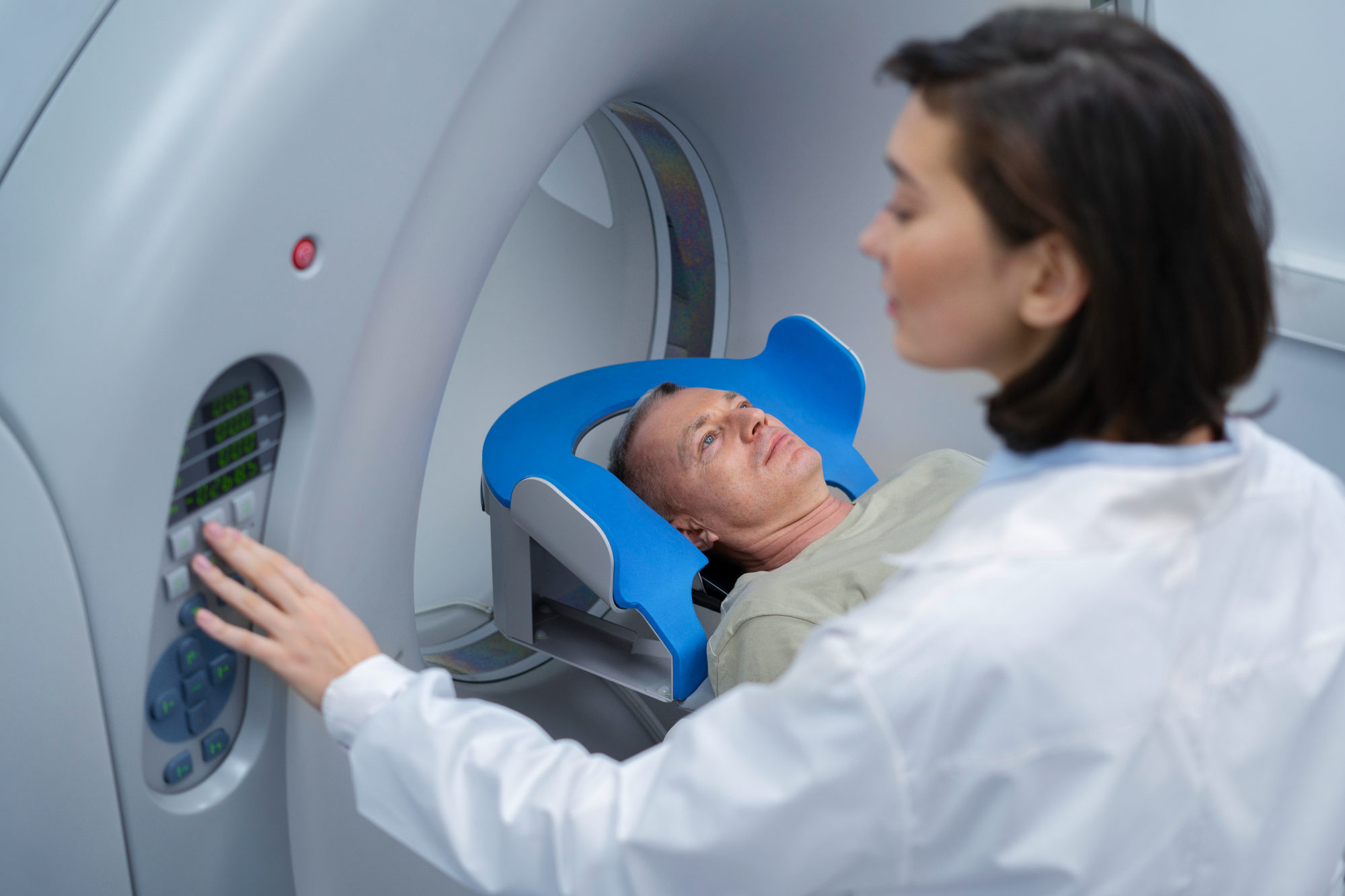 A medical practitioner putting a patient in for a CT.