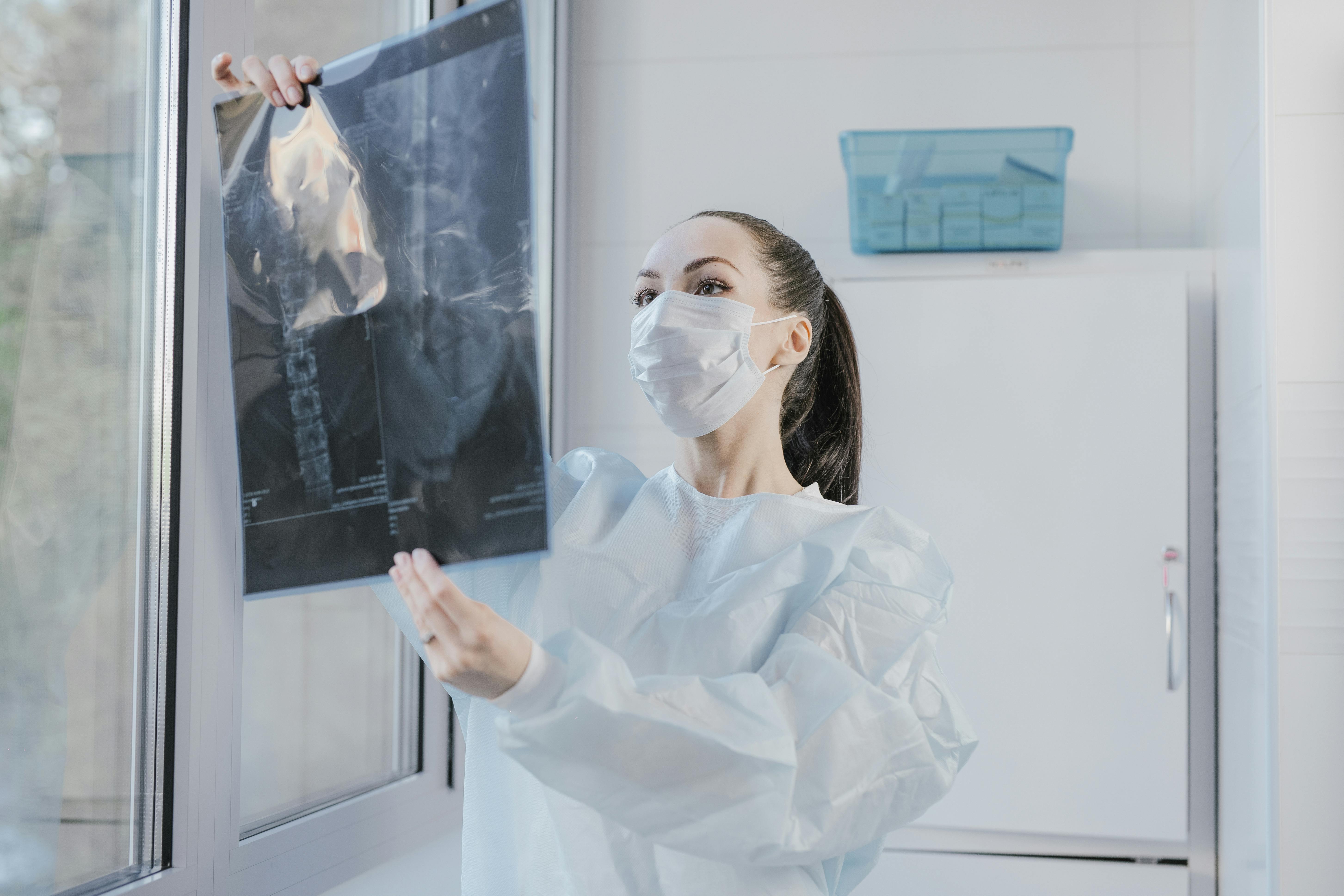 A medical practitioner checking an x-ray.