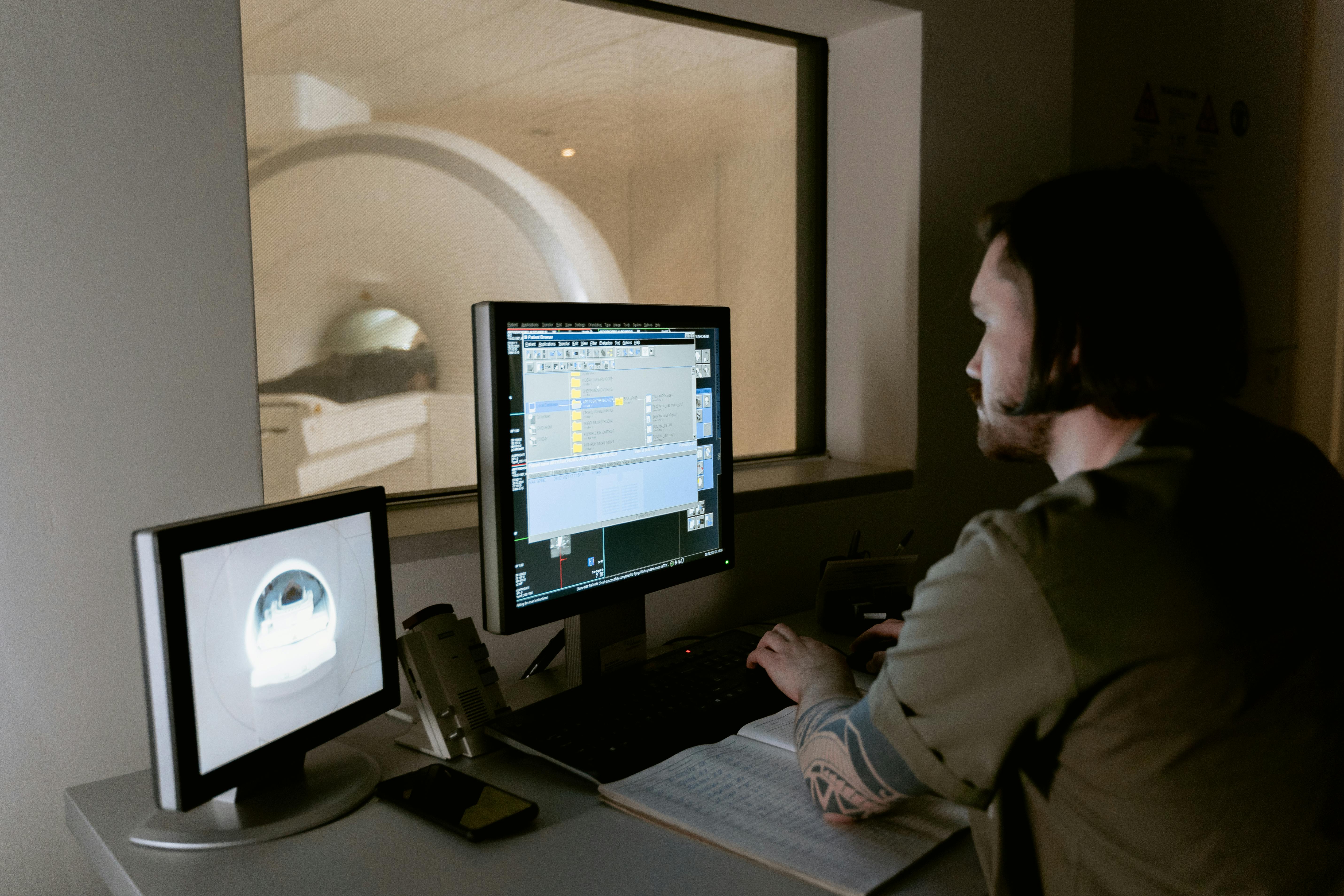 Medical worker looking at the monitor of an MRI