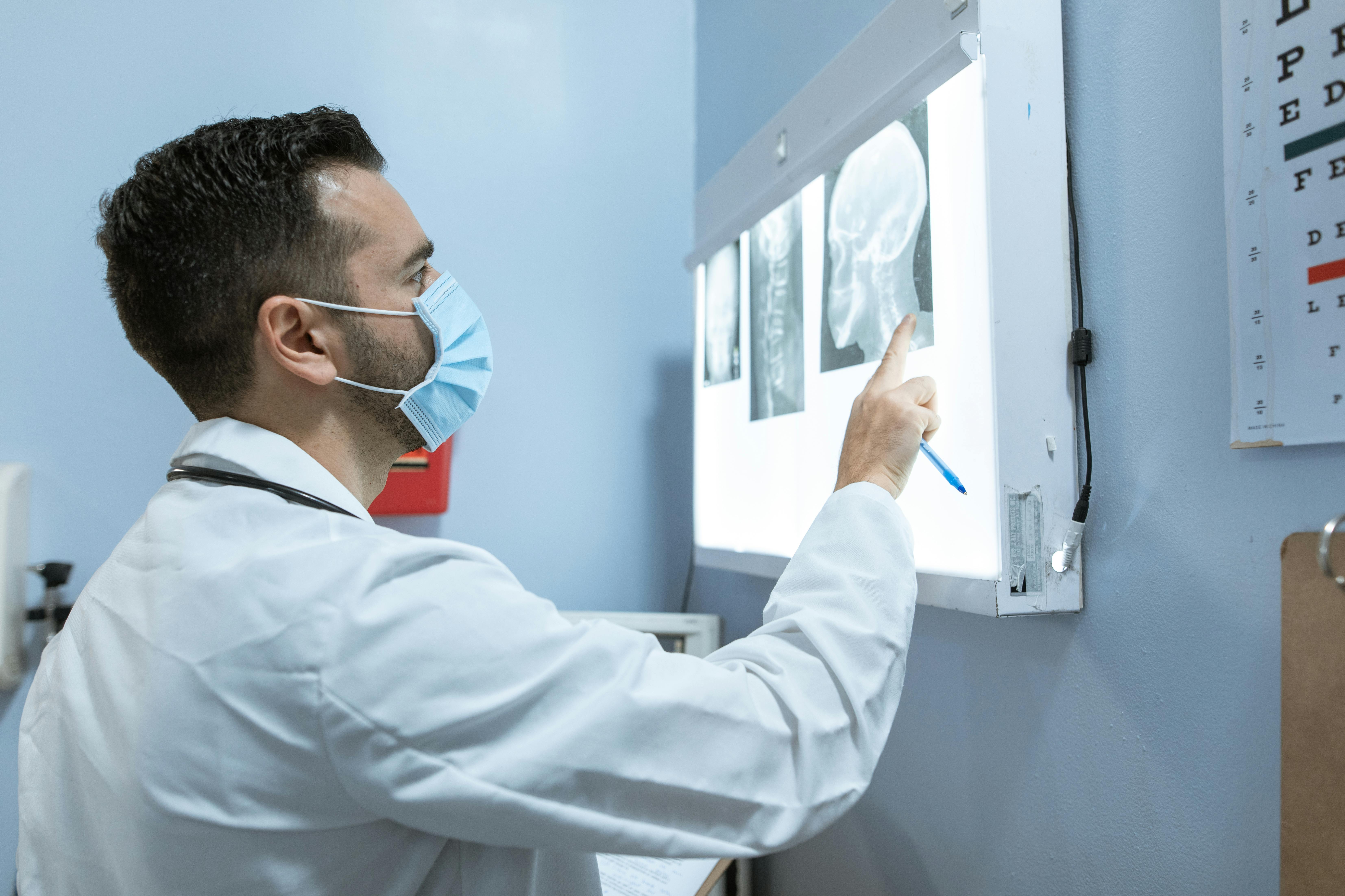 A medical practitioner examining an X-ray