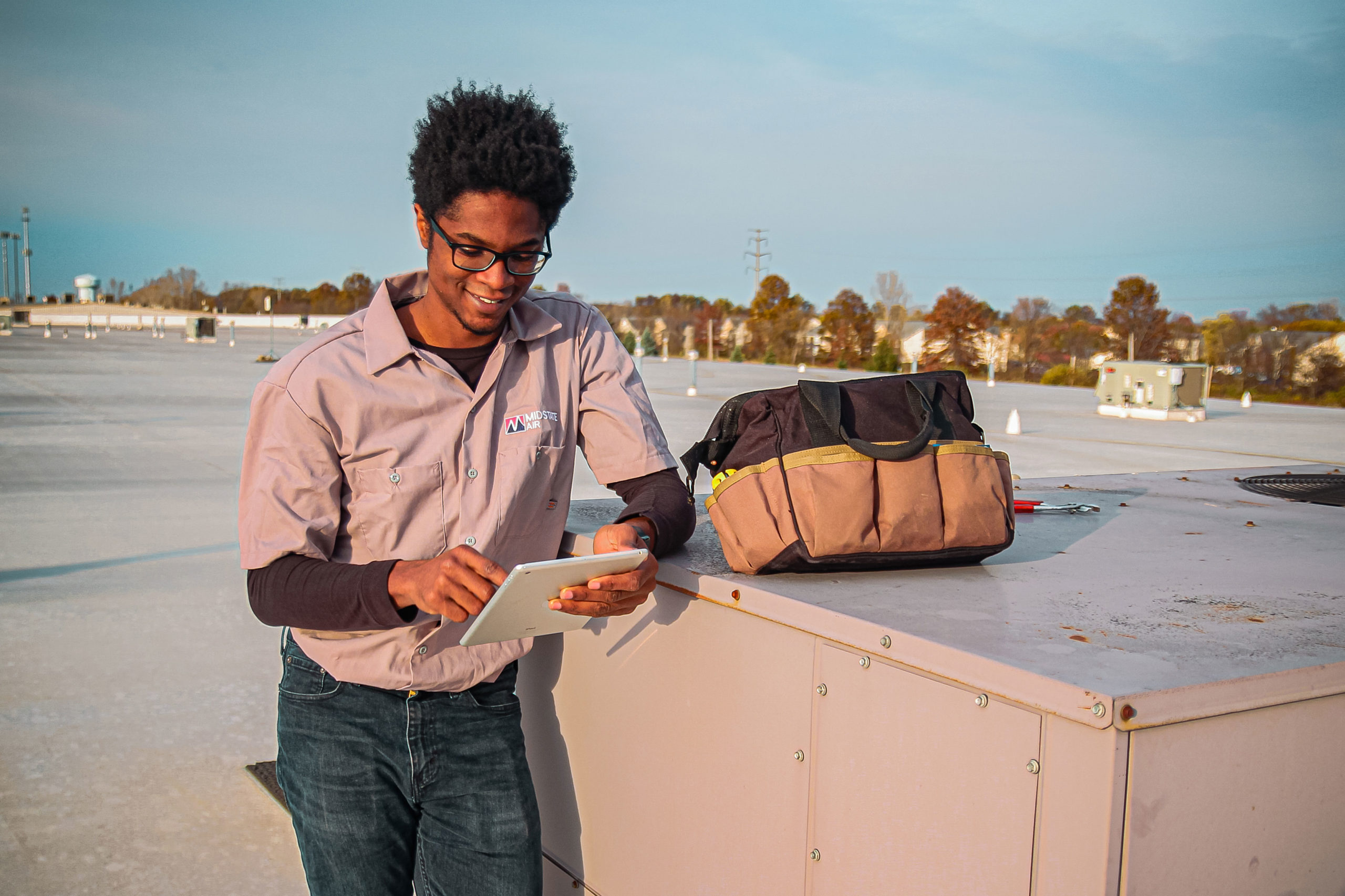 Technician working on a rooftop unit