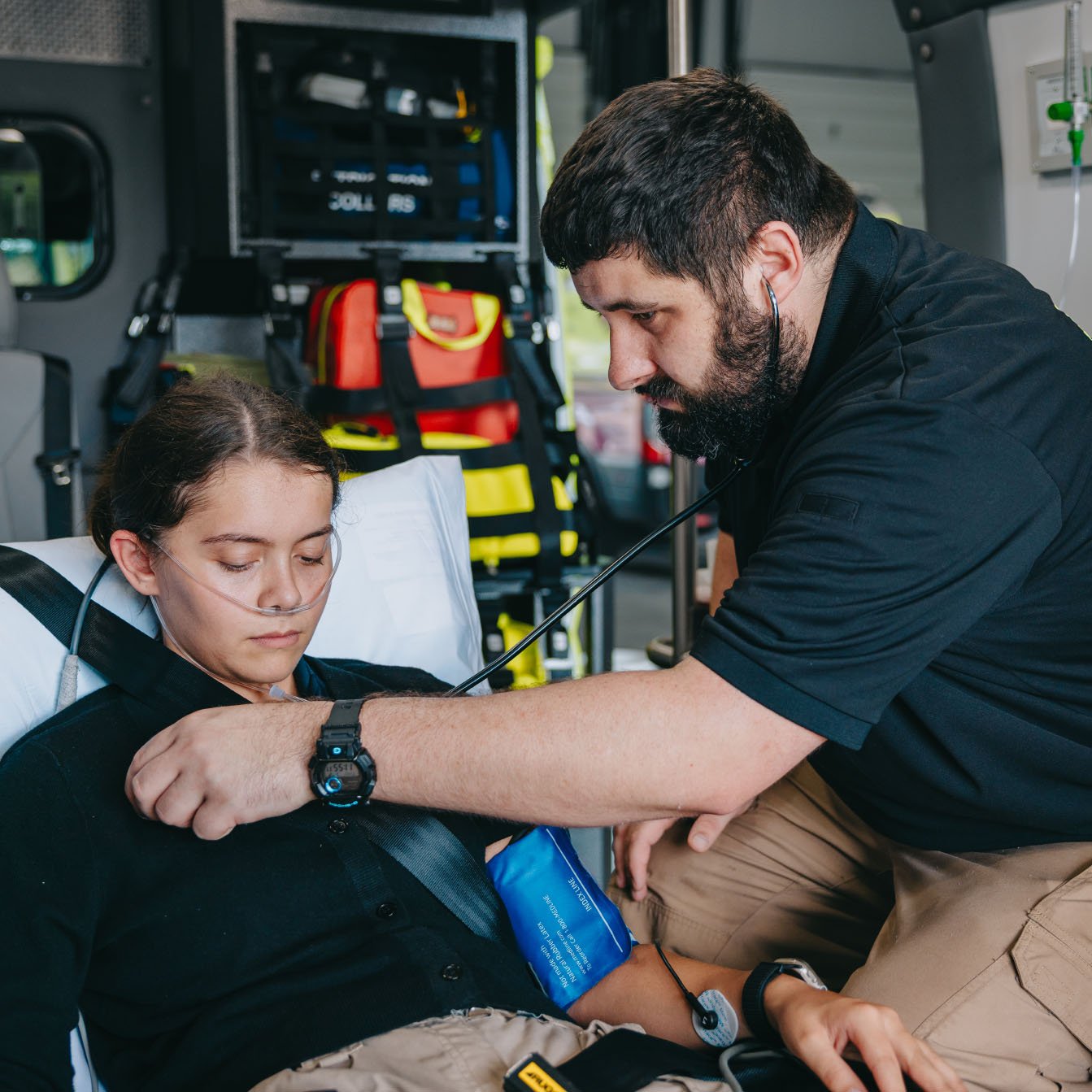 Stark County Ambulance paramedic taking a patient's blood pressure in the back of an ambulance