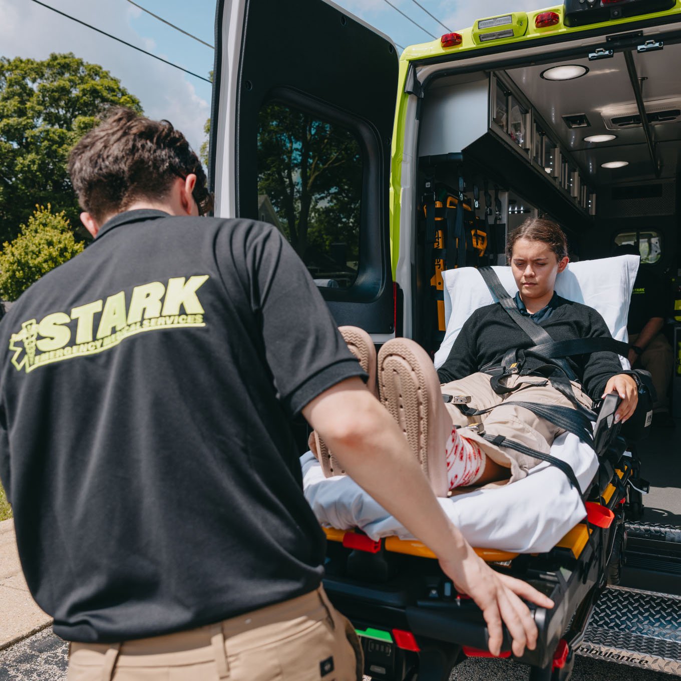 Stark County Ambulance crew loading a patient into the back of an ambulance