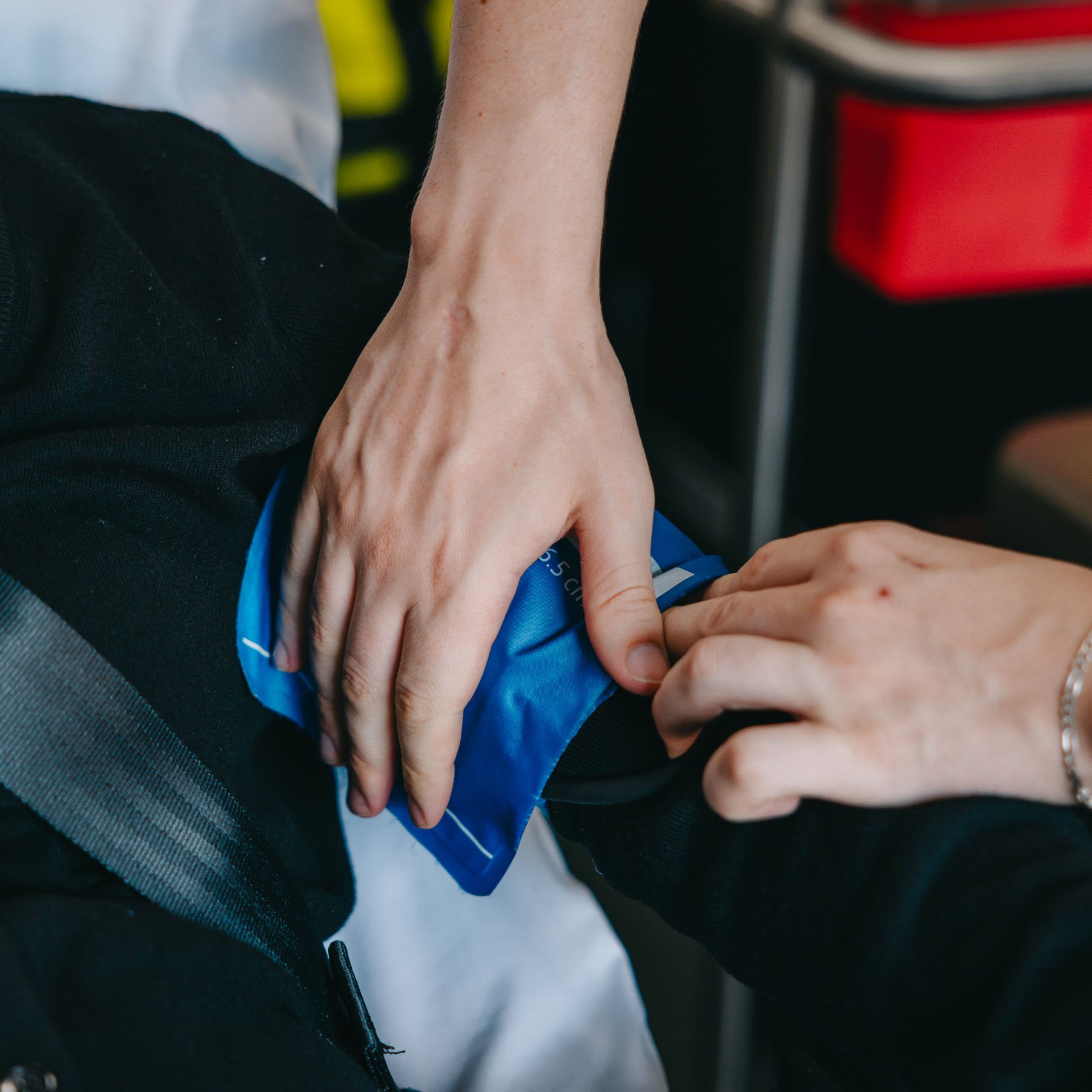 Paramedic applying a cold pack to a patient's arm during transport